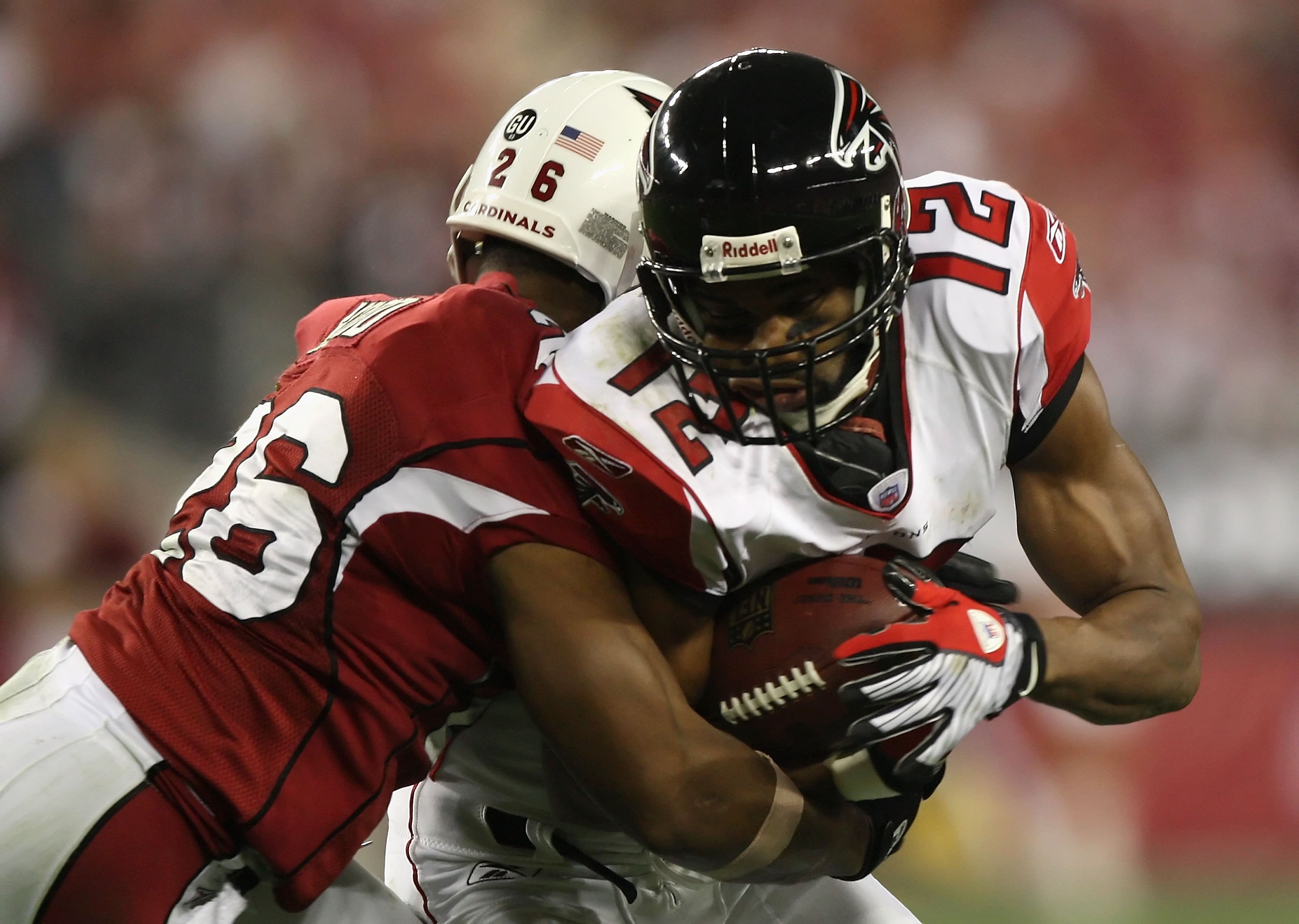 GLENDALE, AZ - JANUARY 03:  Wide receiver Michael Jenkins #12 of the Atlanta Falcons is tackled by  Roderick Hood #26 of the Arizona Cardinals during the NFC Wild Card Game on January 3, 2009 at University of Phoenix Stadium in Glendale, Arizona. The Card