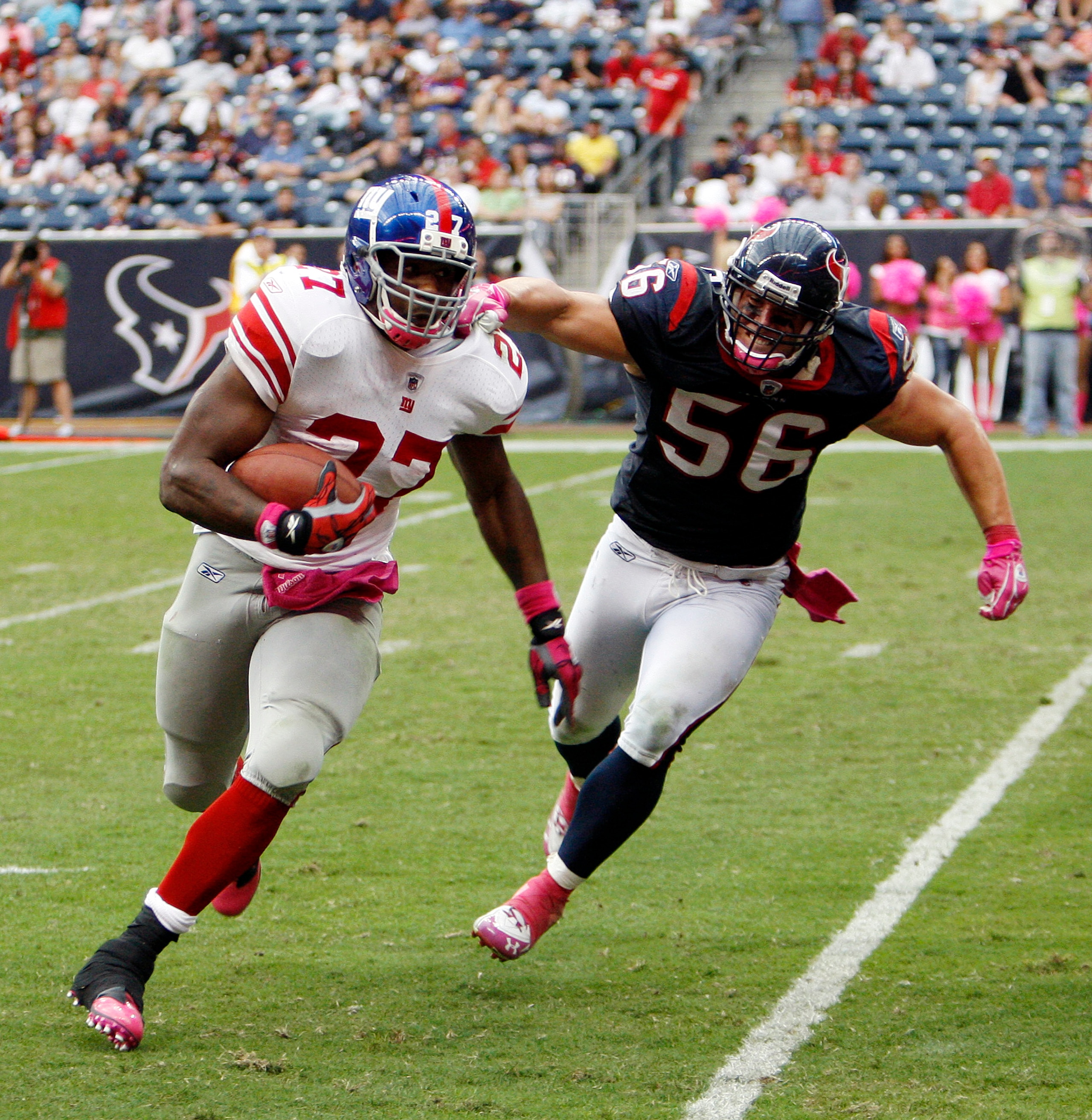 HOUSTON - OCTOBER 10: Running back Brandon Jacobs #27 of the New York Giants eludes the tackle of linebacker Brian Cushing #56 of the Houston Texans at Reliant Stadium on October 10, 2010 in Houston, Texas. New York won 34-10. (Photo by Bob Levey/Getty HOUSTON - OCTOBER 10: Running back Brandon Jacobs #27 of the New York Giants eludes the tackle of linebacker Brian Cushing #56 of the Houston Texans at Reliant Stadium on October 10, 2010 in Houston, Texas. New York won 34-10. (Photo by Bob Levey/Getty