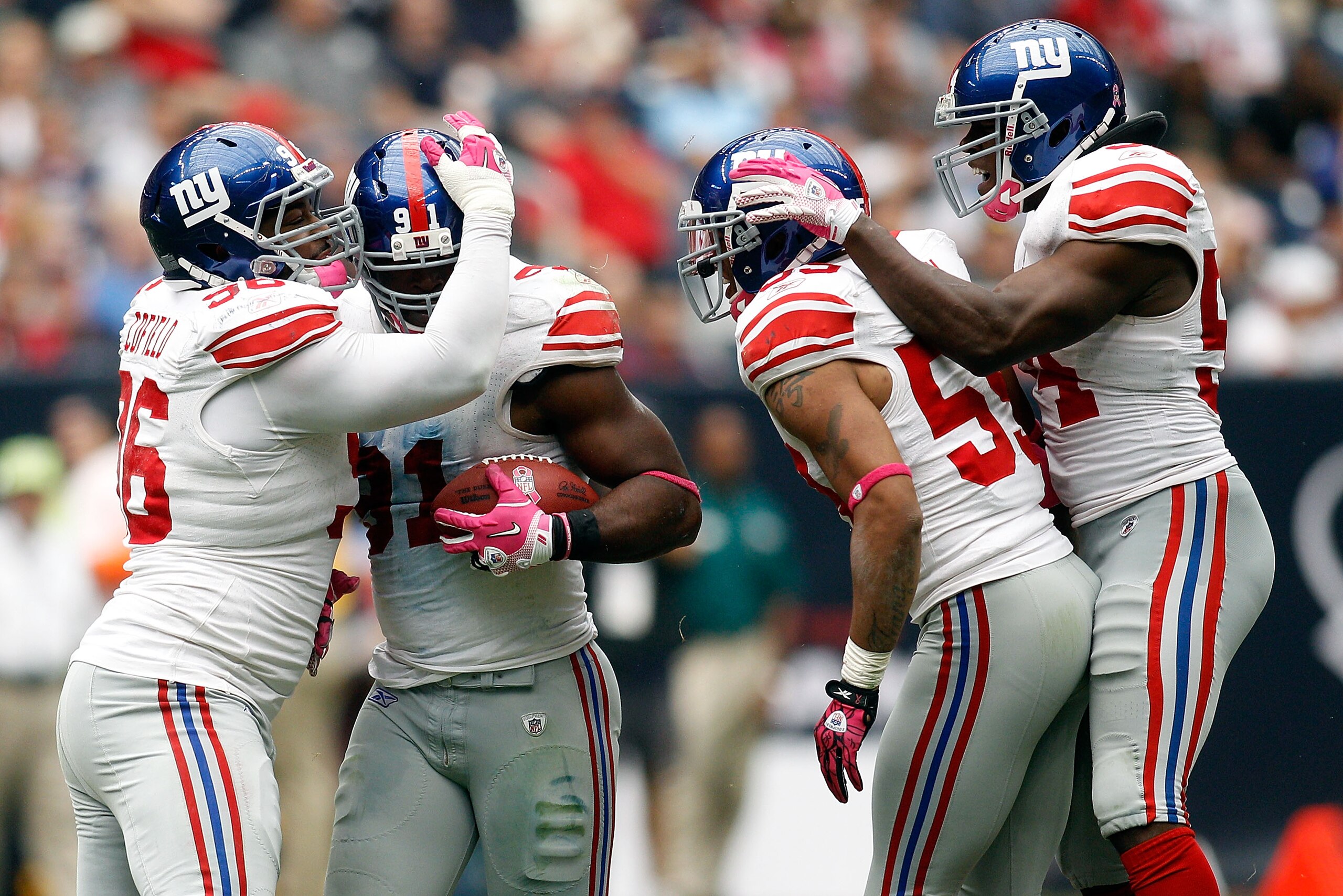 HOUSTON - OCTOBER 10:  Justin Tuck #91 of the New York Giants celebrates after recovering a fumble during the game against the Houston Texans at Reliant Stadium on October 10, 2010 in Houston, Texas.  The Giants defeated the Texans 34-10.  (Photo by Chris