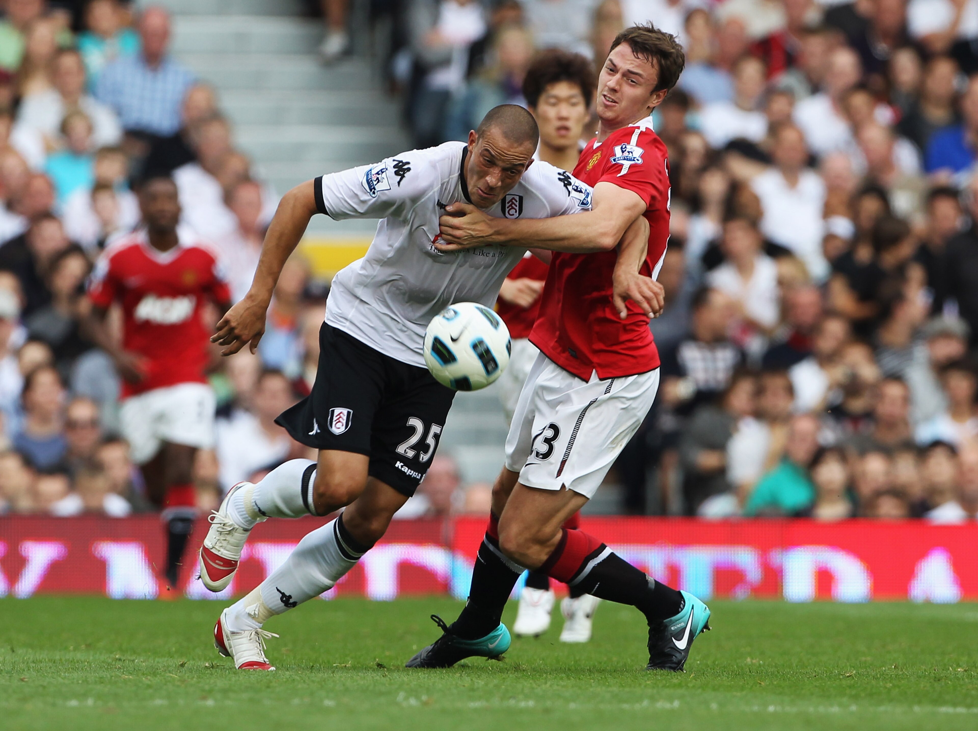LONDON, ENGLAND - AUGUST 22:  Jonny Evans of Manchester United battles with Bobby Zamora of Fulham during the Barclays Premier League match between Fulham and Manchester United at Craven Cottage on August 22, 2010 in London, England.  (Photo by Phil Cole/