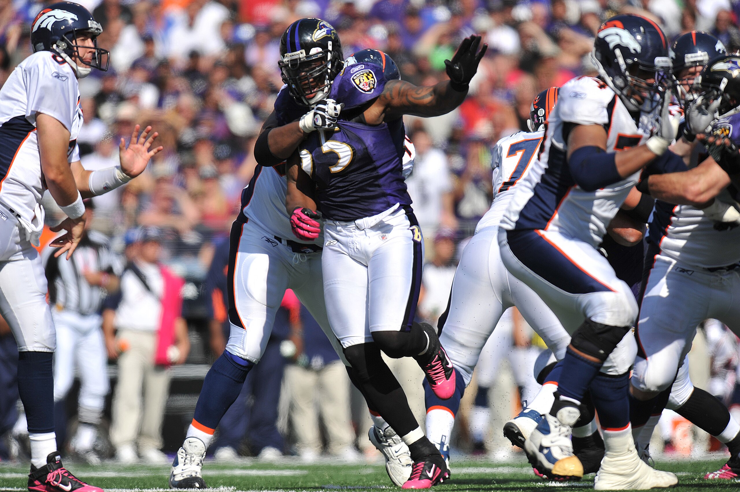 BALTIMORE, MD - OCTOBER 10: Terrell Suggs #55 of the Baltimore Ravens defends against the Denver Broncos at M&T Bank Stadium on October 10, 2010 in Baltimore, Maryland. Players wore pink in recognition of Breast Cancer Awareness Month. The Ravens defeated