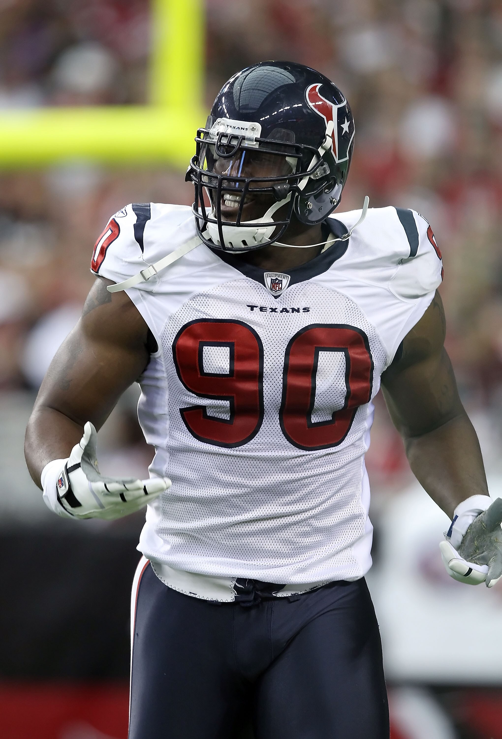 GLENDALE, AZ - AUGUST 14:  Defensive end Mario Williams #90 of the Houston Texans celebrates after a first quarter sack agianst the Arizona Cardinals during preseason NFL game at the University of Phoenix Stadium on August 14, 2010 in Glendale, Arizona.