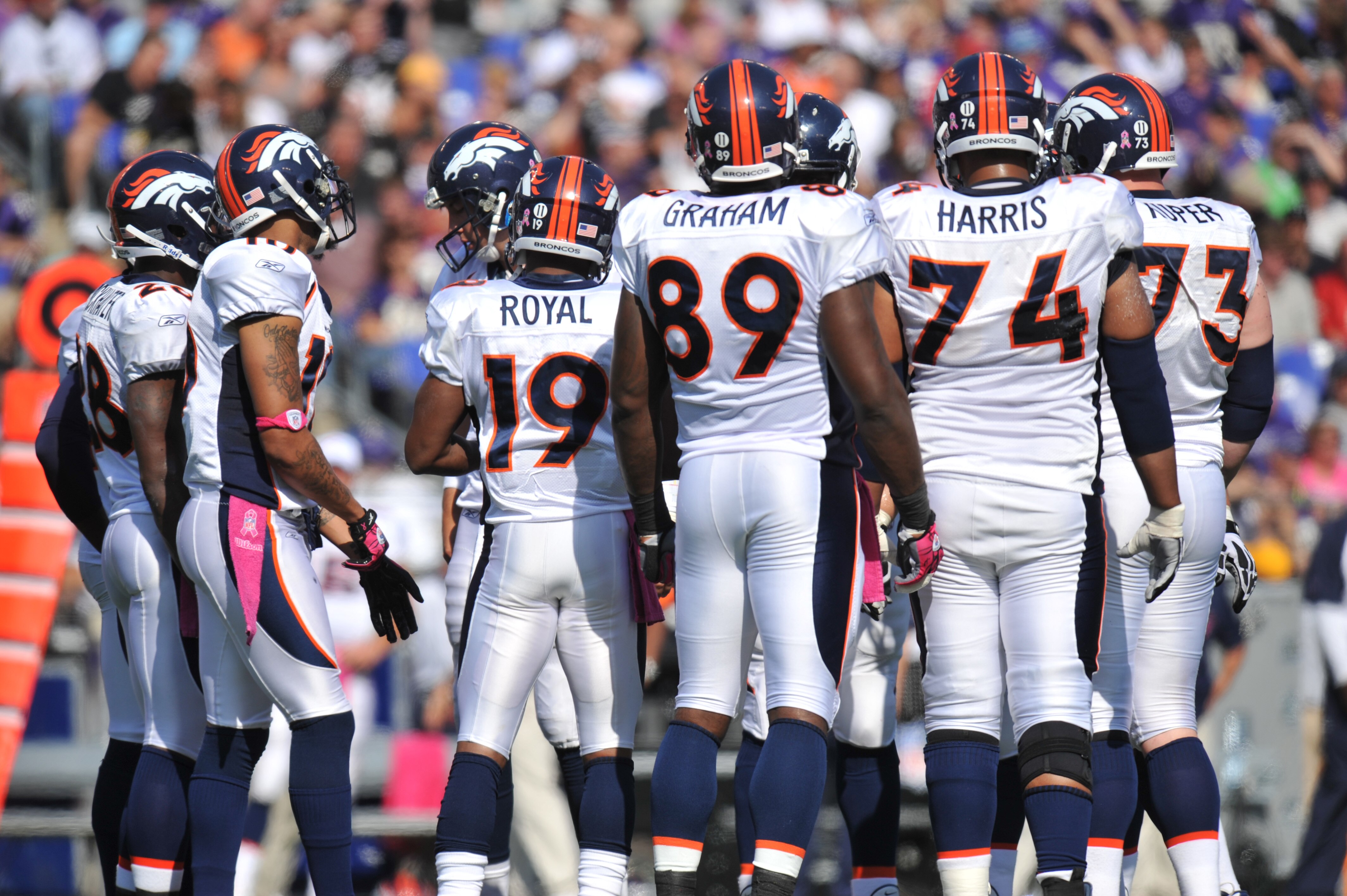 BALTIMORE, MD - OCTOBER 10: The Denver Broncos offense huddles during the game against the Baltimore Ravens at M&T Bank Stadium on October 10, 2010 in Baltimore, Maryland. Players wore pink in recognition of Breast Cancer Awareness Month. The Ravens defea