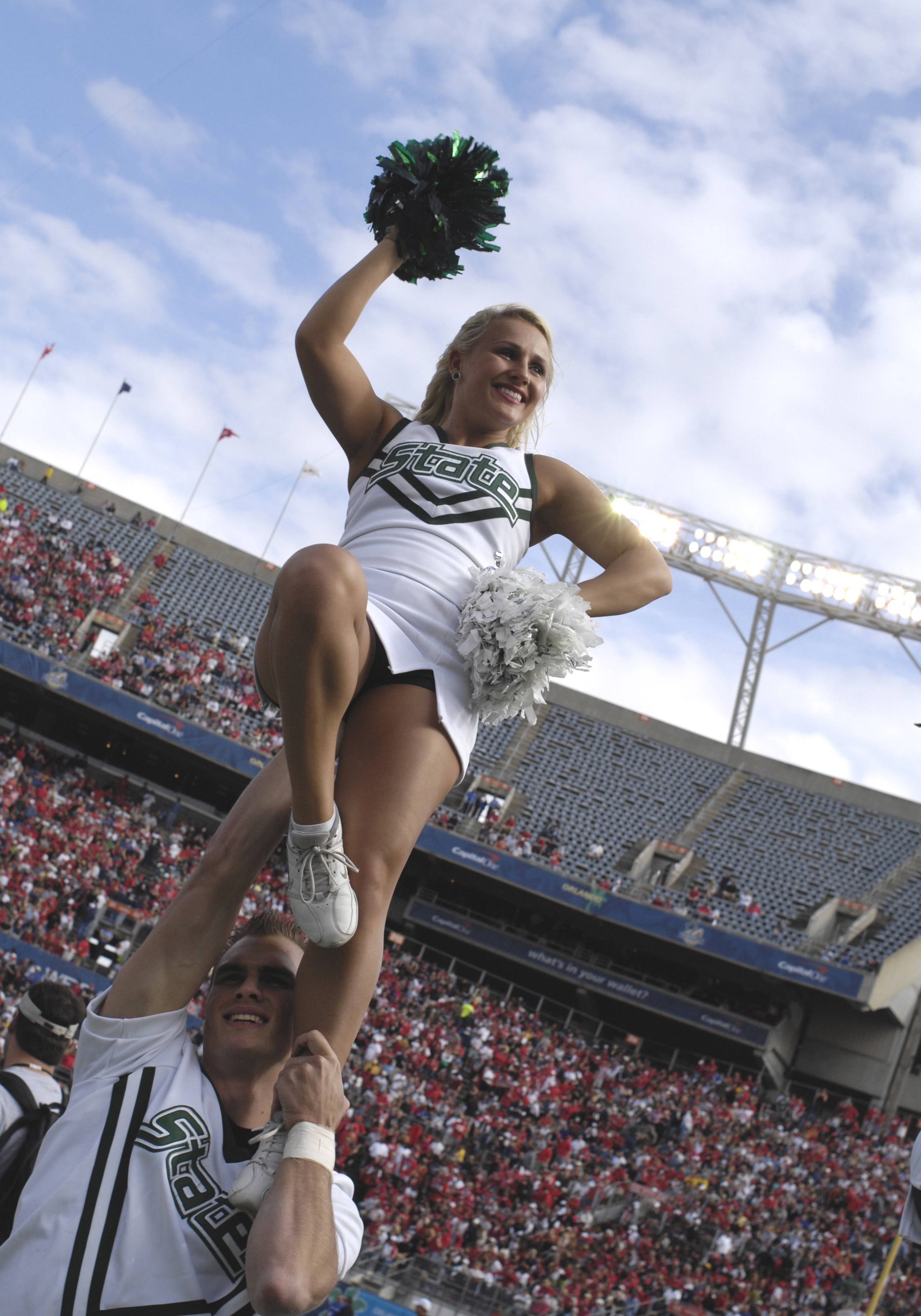 ORLANDO, FL - JANUARY 1: A cheerleader of the Michigan State Spartans entertains during play against the Georgia Bulldogs at the 2009 Capital One Bowl at the Citrus Bowl on January 1, 2009 in Orlando, Florida.  (Photo by Al Messerschmidt/Getty Images)