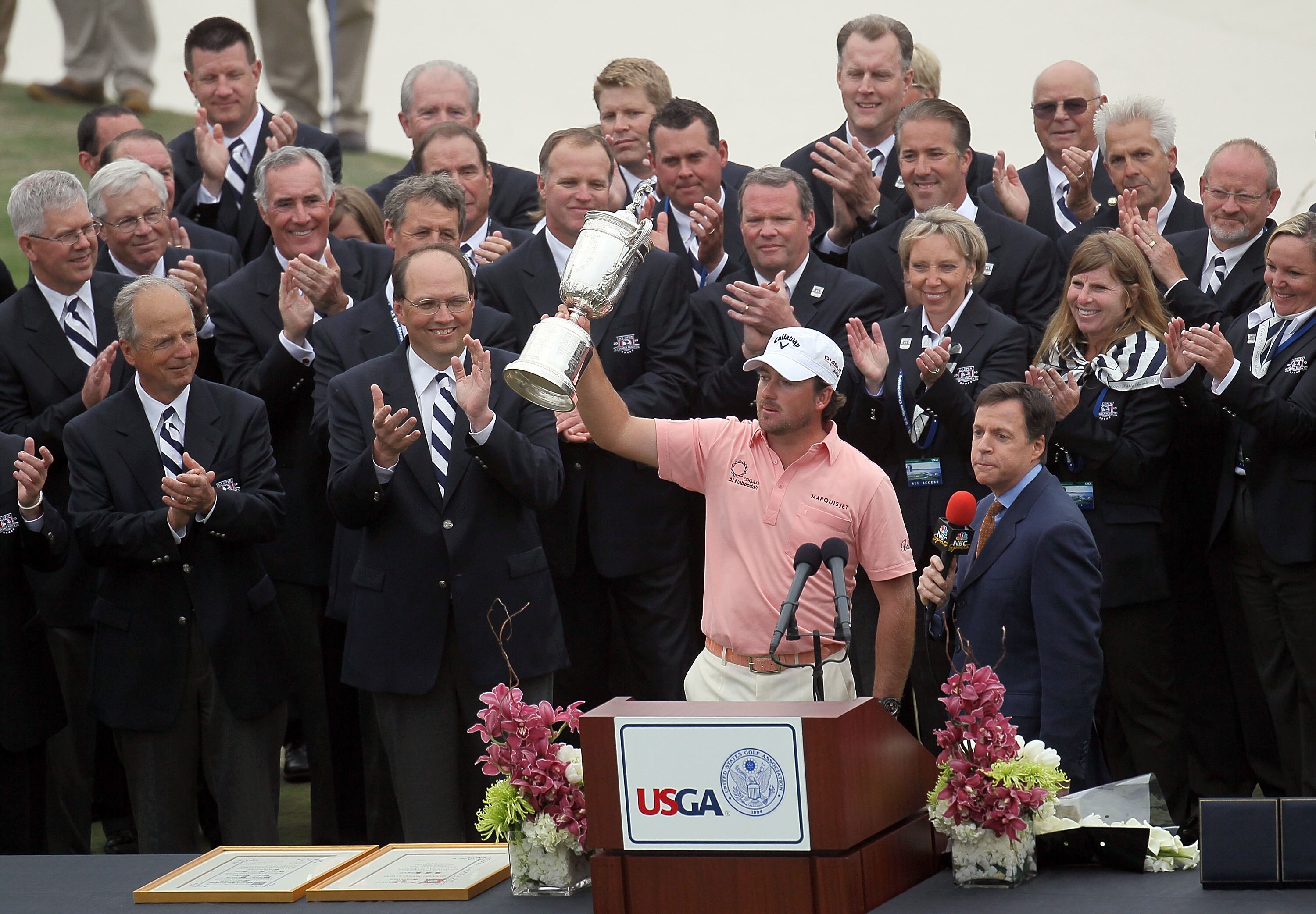 PEBBLE BEACH, CA - JUNE 20:  Graeme McDowell (R) of Northern Ireland celebrates with the trophy on the 18th green as Bob Costas of NBC Sports looks on after winning the 110th U.S. Open at Pebble Beach Golf Links on June 20, 2010 in Pebble Beach, Californi