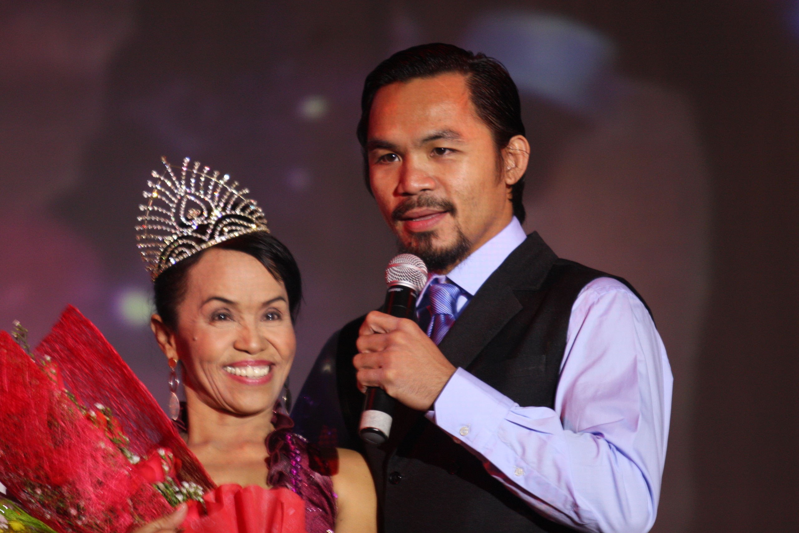 GENERAL SANTOS, PHILIPPINES - MAY 15: World welterweight boxing champion Manny Pacquiao is seen with his mother Dionisia Pacquiao at the KCC Mall on May 15, 2010 in General Santos, Philippines. Pacquiao was there to celebrate his election on becoming a m GENERAL SANTOS, PHILIPPINES - MAY 15: World welterweight boxing champion Manny Pacquiao is seen with his mother Dionisia Pacquiao at the KCC Mall on May 15, 2010 in General Santos, Philippines. Pacquiao was there to celebrate his election on becoming a m