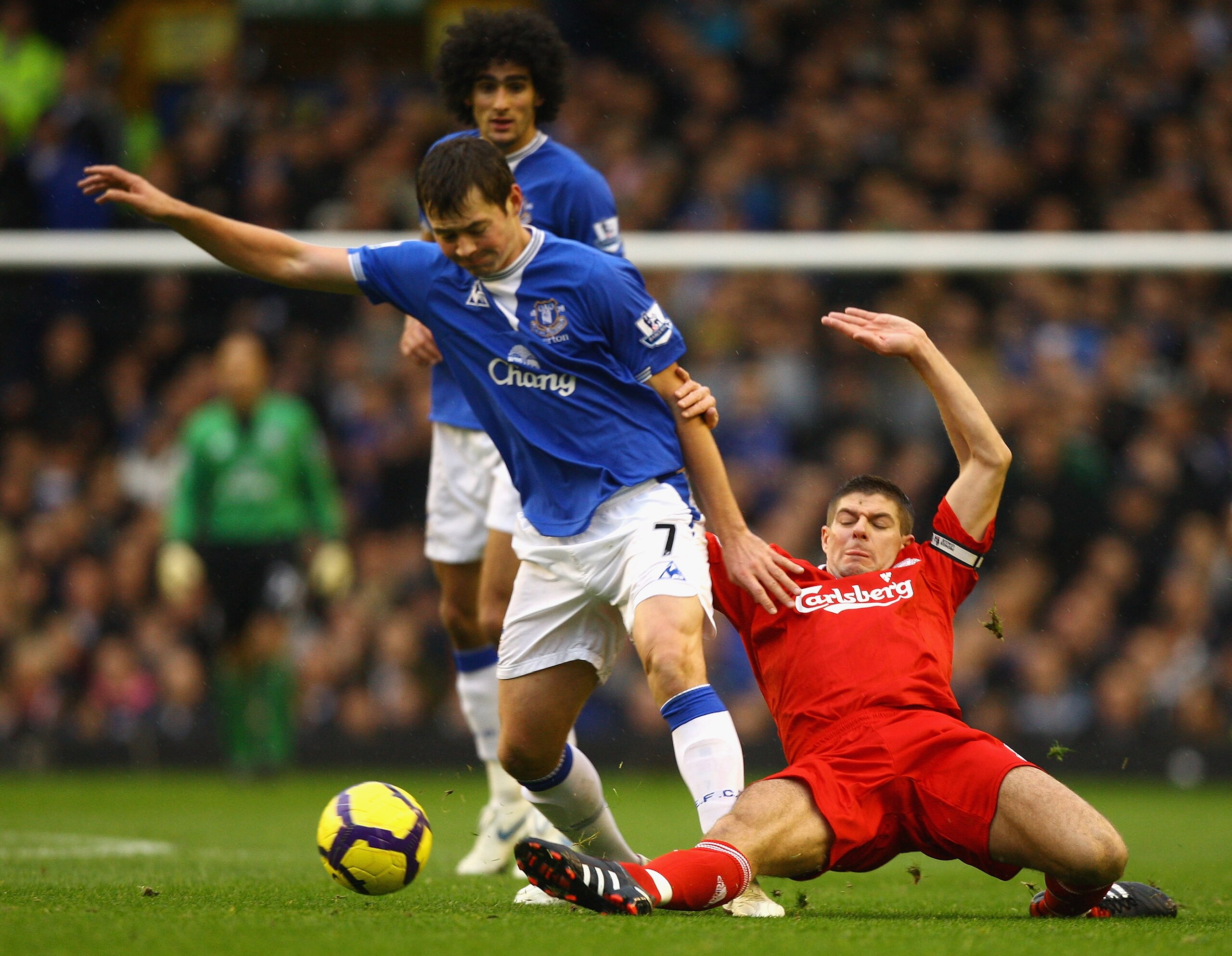 LIVERPOOL, ENGLAND - NOVEMBER 29:  Diniyar Bilyaletdinov of Everton is tackled by Steven Gerrard of Liverpool during the Barclays Premier League match between Everton and Liverpool at Goodison Park on November 29, 2009 in Liverpool, England. (Photo by Mat