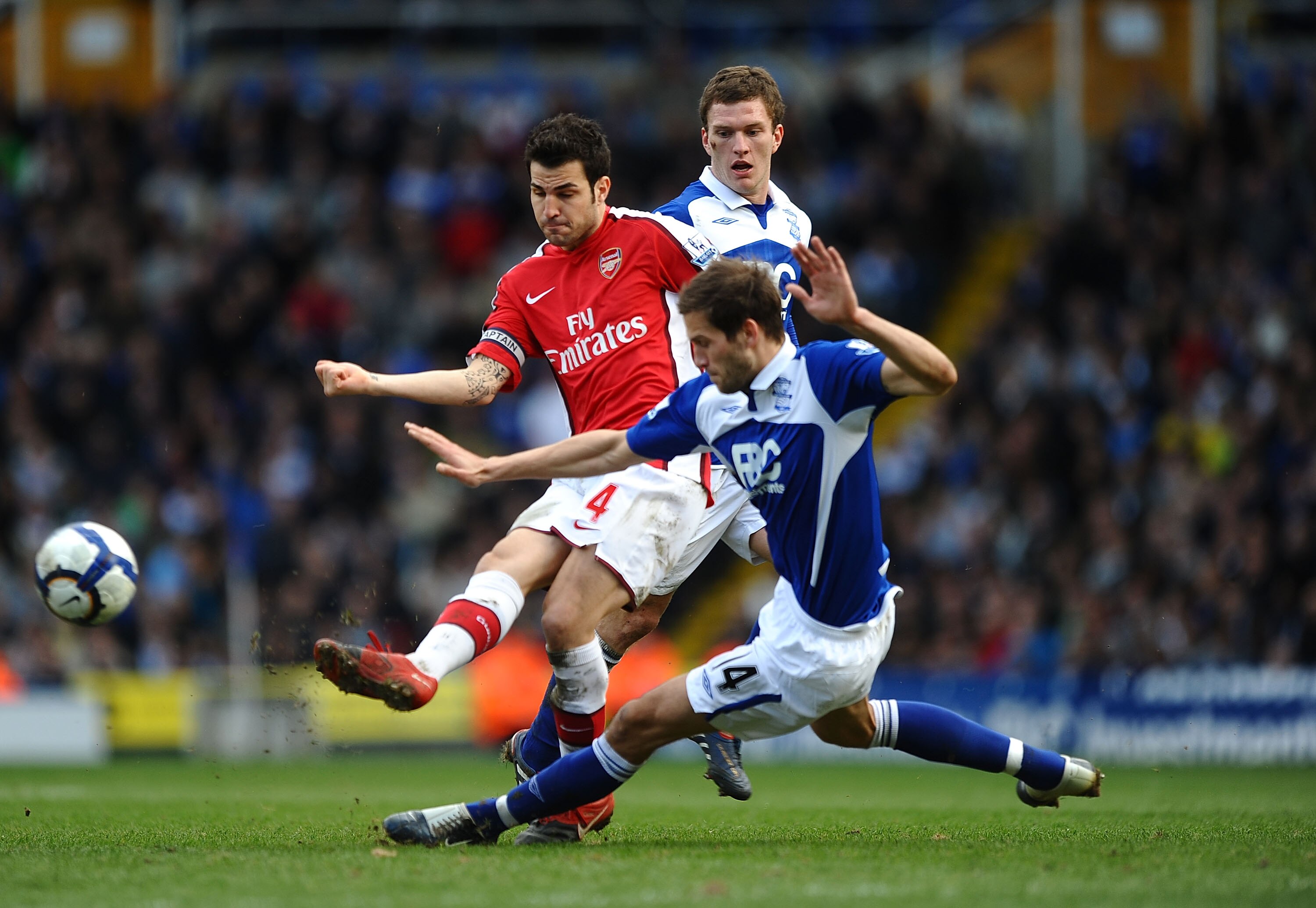 BIRMINGHAM, ENGLAND - MARCH 27: Cesc Fabregas of Arsenal battles with Roger Johnson of Birmingham City during the Barclays Premier League match between Birmingham City and Arsenal at St. Andrews Stadium on March 27, 2010 in Birmingham, England.  (Photo by