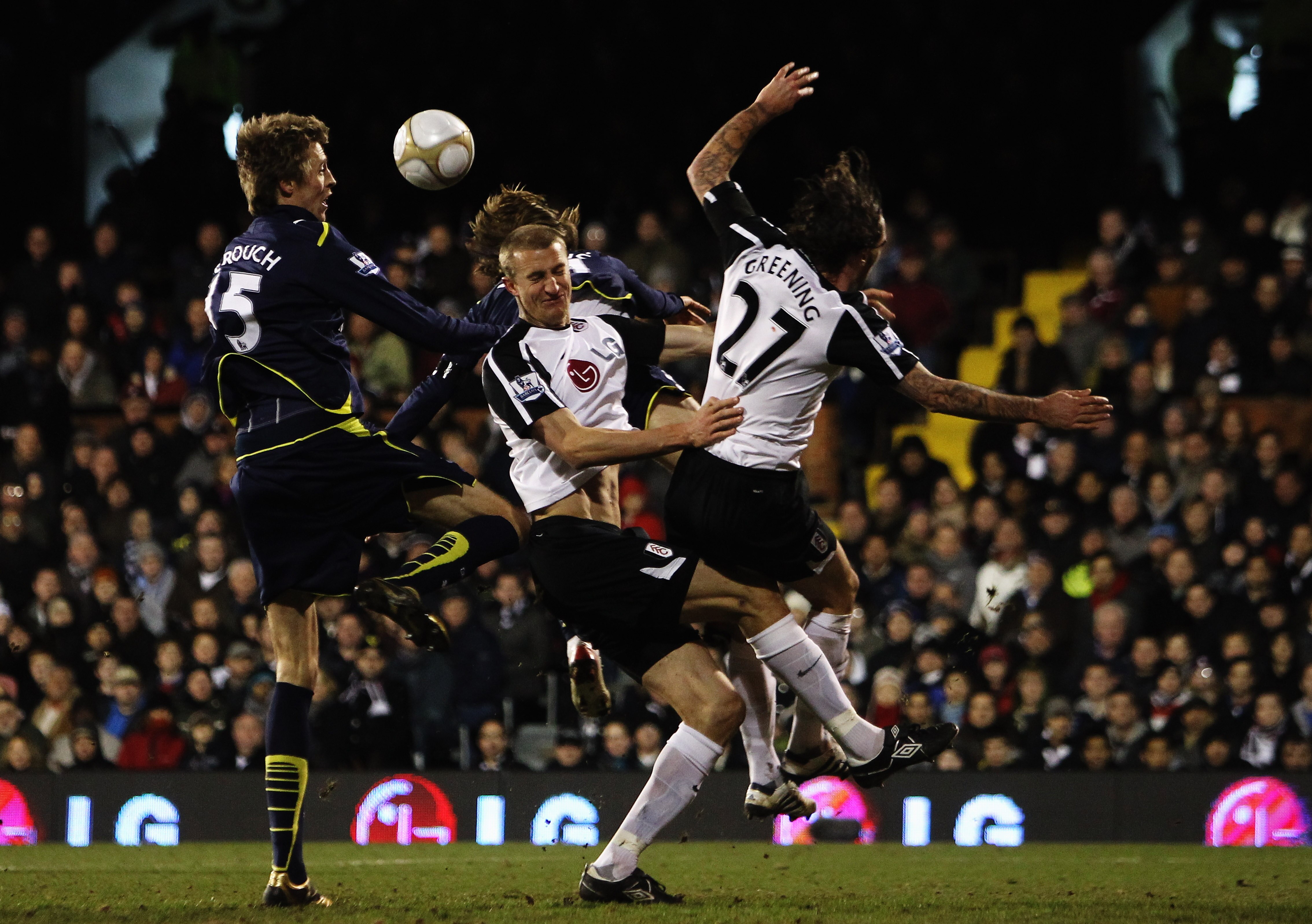 LONDON - MARCH 06:  Peter Crouch (L) of Tottenham Hotspur rises above the challenge of Jonathan Greening (R) and Brede Hangeland (C) of Fulham during the FA Cup sponsored by E.ON Quarter Final match between Fulham and Tottenham Hotspur at Craven Cottage o