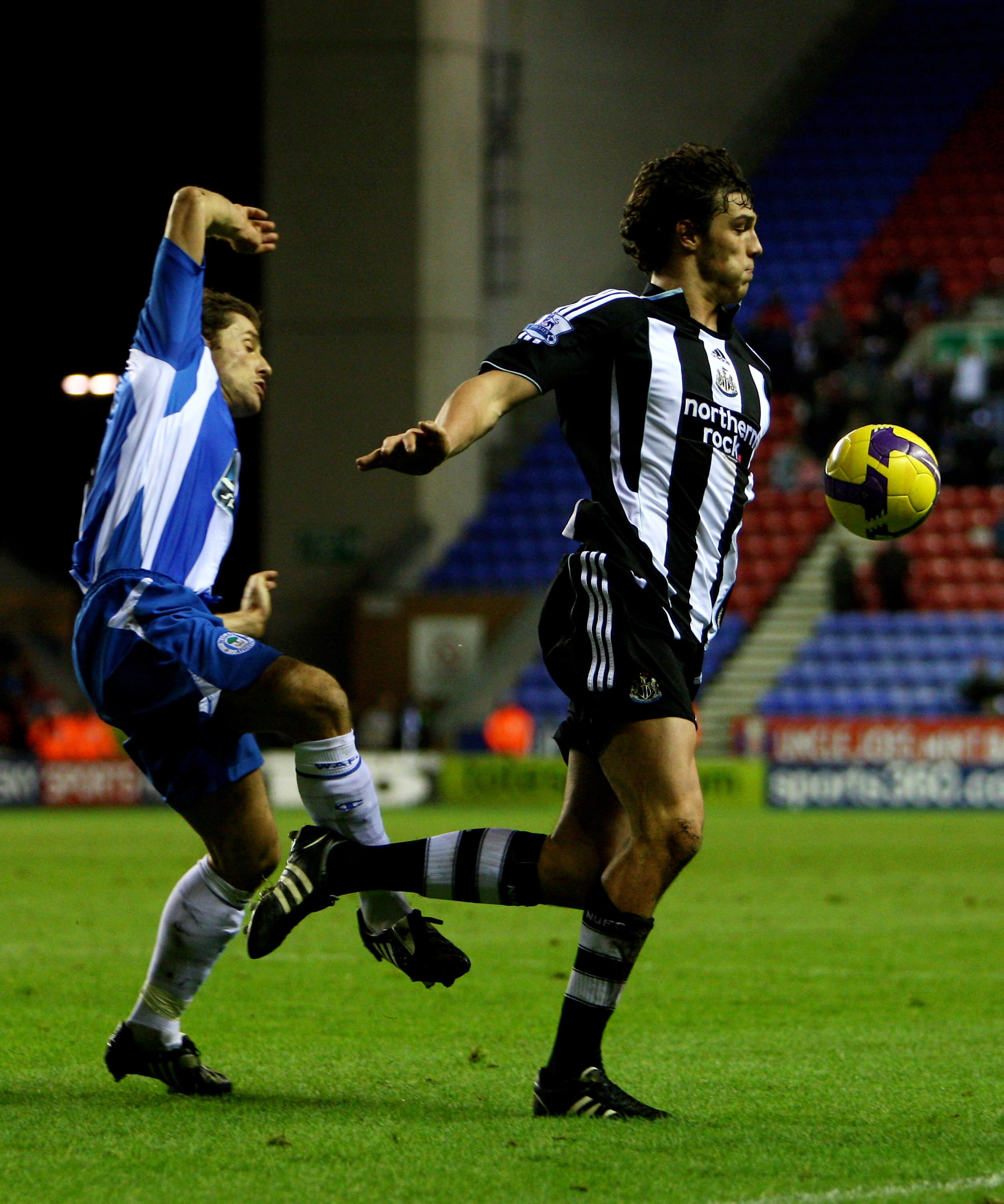 WIGAN, UNITED KINGDOM - DECEMBER 26:  Andrew Carroll of Newcastle tries to claim a last ditch penalty after being tackle by Paul Scharner of Wigan during the Barclays Premier League match between Wigan Athletic and Newcastle United at the JJB Stadium on D