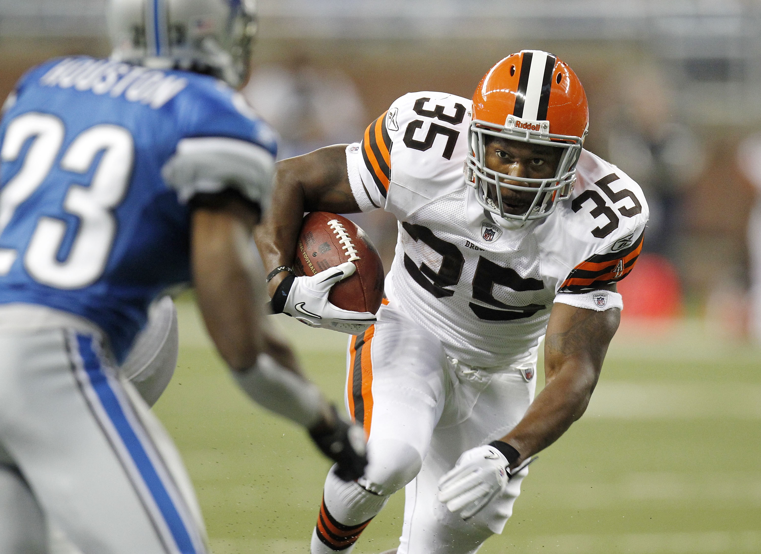 DETROIT - AUGUST 28: Jerome Harrison #35 of the Cleveland Browns looks to get around Chris Houston #23 of the Detroit Lions during a preseason game on August 28, 2010 at Ford Field in Detroit, Michigan. (Photo by Gregory Shamus/Getty Images)
