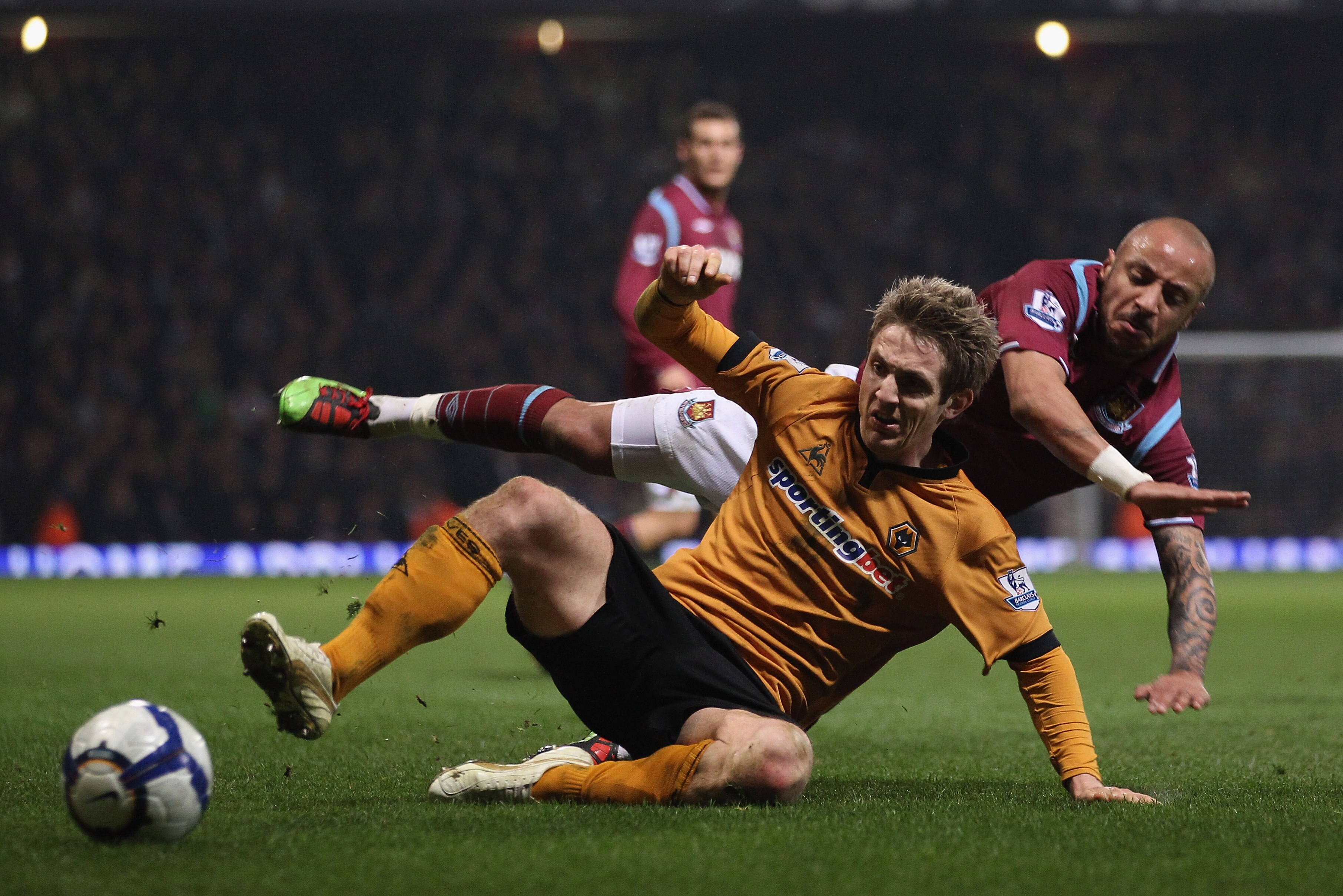 LONDON, ENGLAND - MARCH 23:  Julien Faubert of West Ham and Kevin Doyle of Wolverhampton Wanderers in action during the Barclays Premier League match between West Ham United v Wolverhampton Wanderers at Upton Park on March 23, 2010 in London, England.  (P