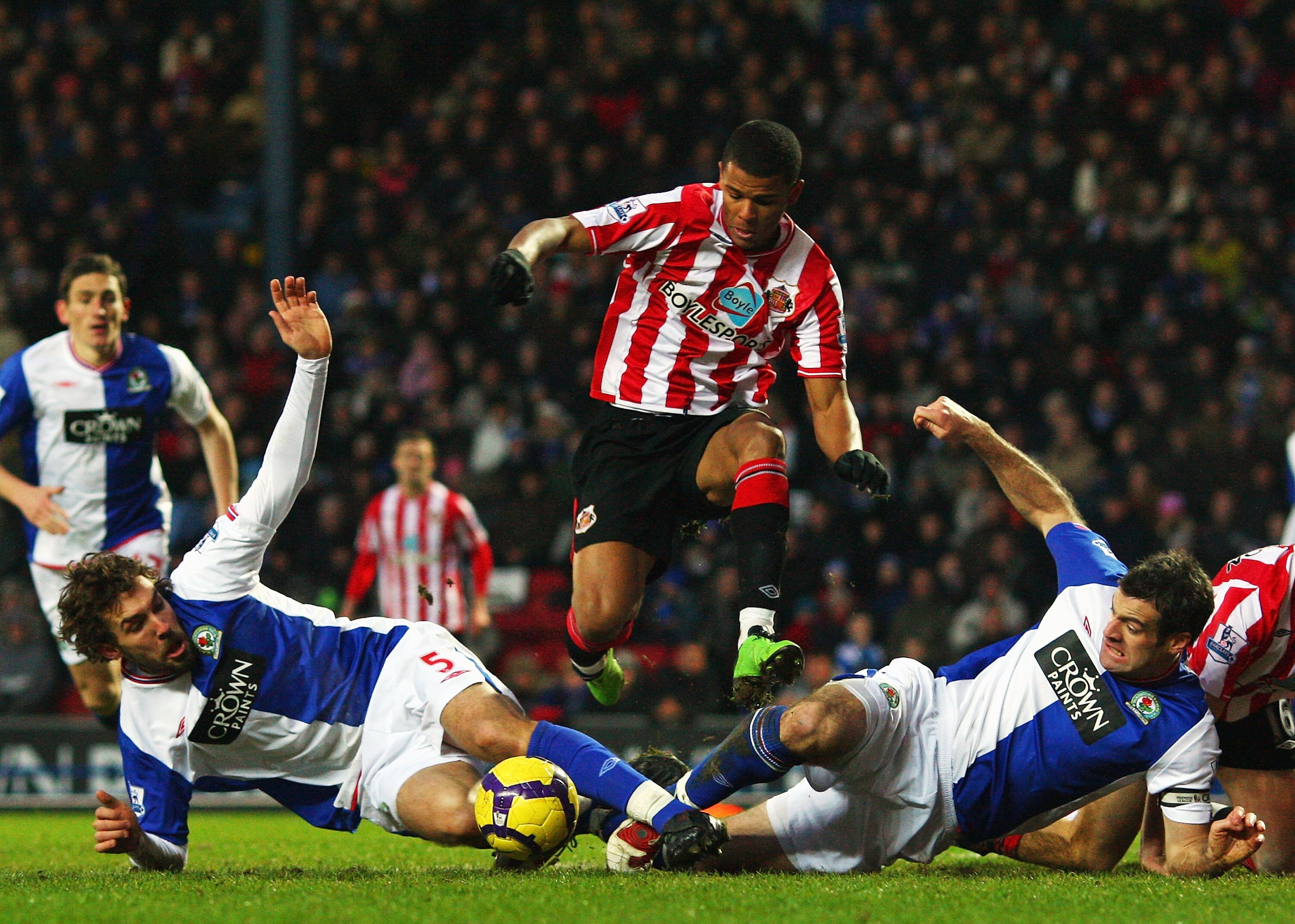 BLACKBURN, ENGLAND - DECEMBER 28:  Fraizer Campbell of Sunderland leaps over a challenge from Gael Givet (L) and Ryan Nelsen (R) of Blackburn Rovers during the Barclays  Premier League match between Blackburn Rovers and Sunderland at Ewood Park on Decembe