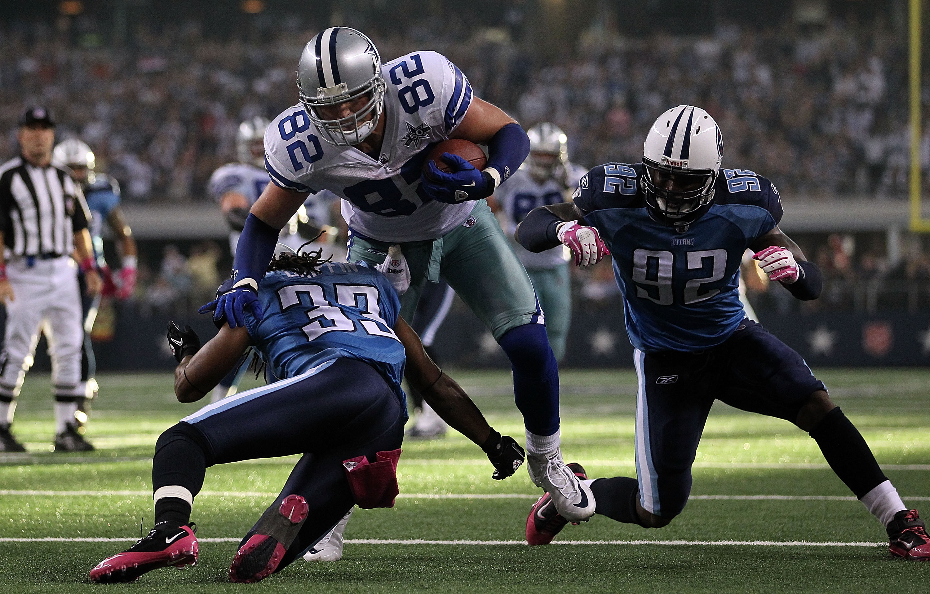 ARLINGTON, TX - OCTOBER 10:  Wide receiver Jason Witten #82 of the Dallas Cowboys runs for a touchdown against Michael Griffin #33 and Will Witherspoon #92 of the Tennessee Titans at Cowboys Stadium on October 10, 2010 in Arlington, Texas.  (Photo by Rona