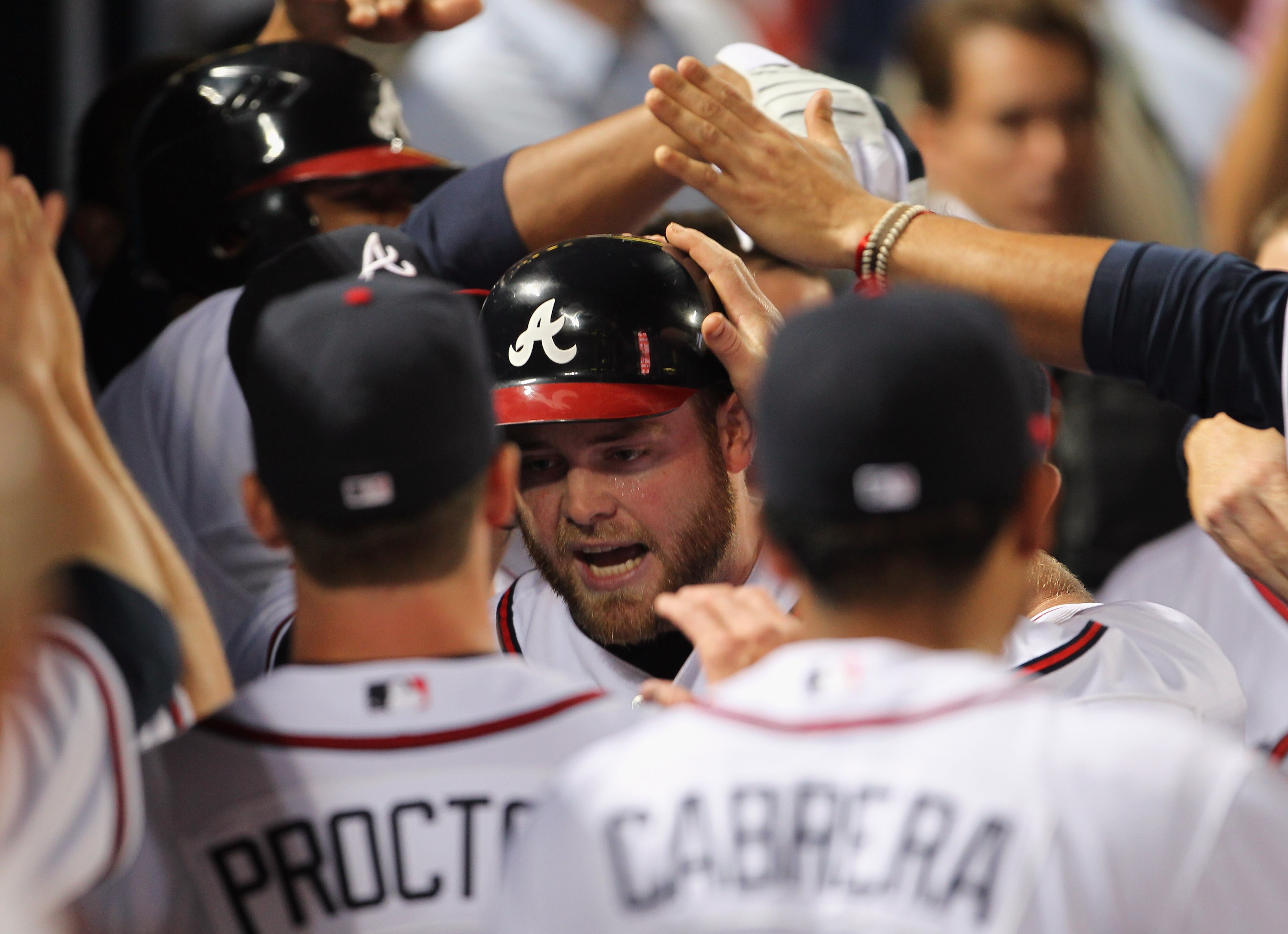 ATLANTA - OCTOBER 11:  Brian McCann #16 of the Atlanta Braves is congratulated by teammates after hitting a solo home run during the 6th inning of Game Four of the NLDS of the 2010 MLB Playoffs against the San Francisco Giants on October 11, 2010  at Turn
