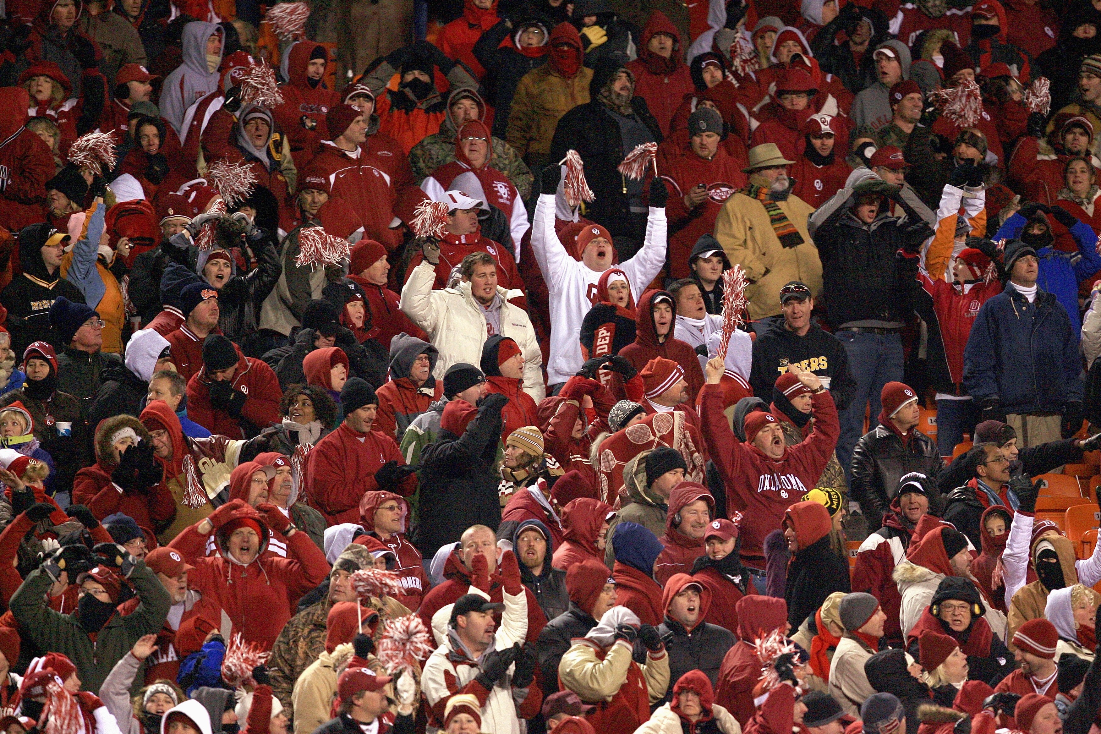 KANSAS CITY, MO - DECEMBER 06:  Fans of the Oklahoma Sooners cheer in the stands during the Big 12 Championship game against the Missouri Tigers on December 6, 2008 at Arrowhead Stadium in Kansas City, Missouri. (Photo by Jamie Squire/Getty Images)