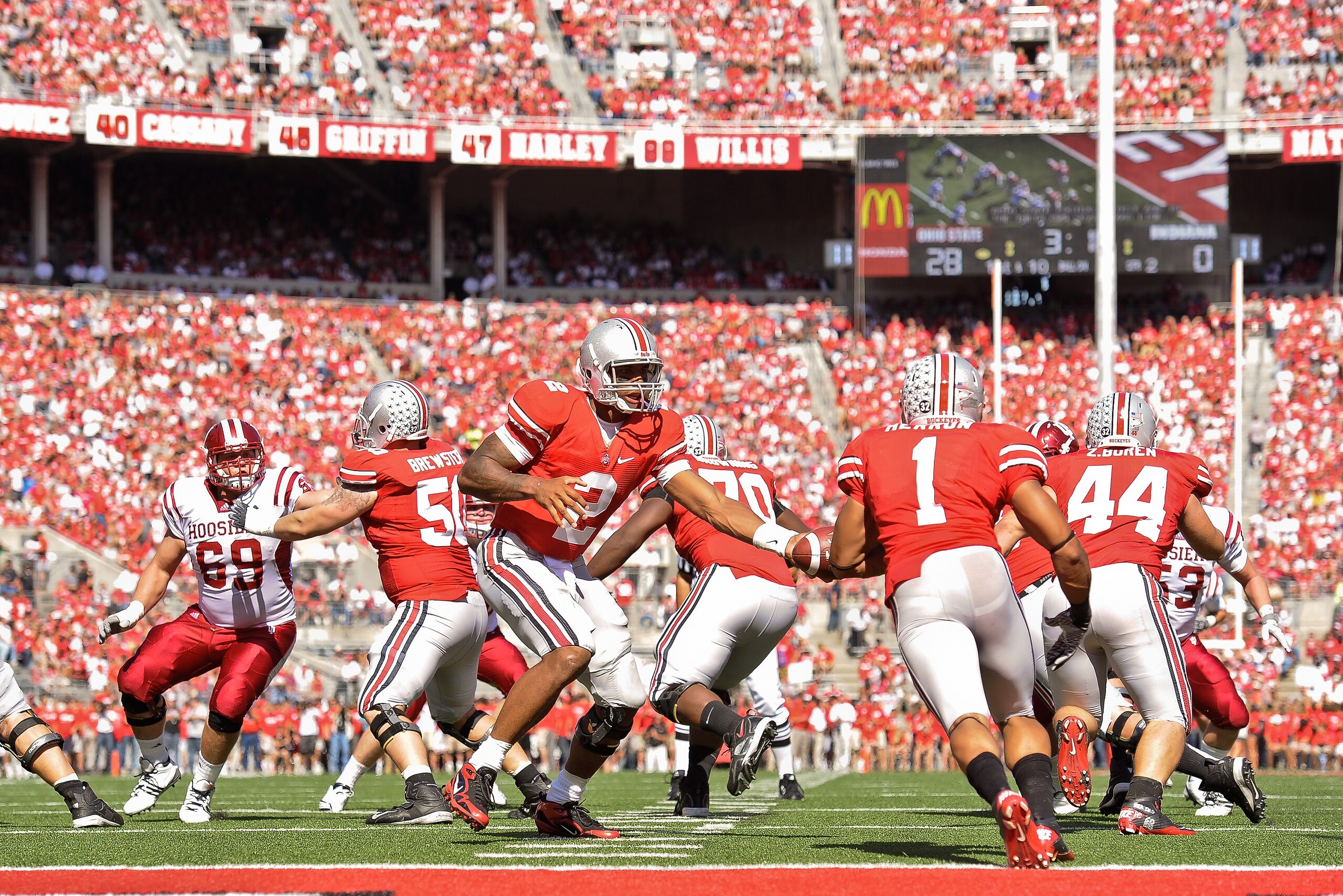 COLUMBUS, OH - OCTOBER 9: Quarterback Terrelle Pryor #2 of the Ohio State Buckeyes hands off to Dan Herron #1 of the Ohio State Buckeyes against the Indiana Hoosiers at Ohio Stadium on October 9, 2010 in Columbus, Ohio. (Photo by Jamie Sabau/Getty Imag COLUMBUS, OH - OCTOBER 9: Quarterback Terrelle Pryor #2 of the Ohio State Buckeyes hands off to Dan Herron #1 of the Ohio State Buckeyes against the Indiana Hoosiers at Ohio Stadium on October 9, 2010 in Columbus, Ohio. (Photo by Jamie Sabau/Getty Imag