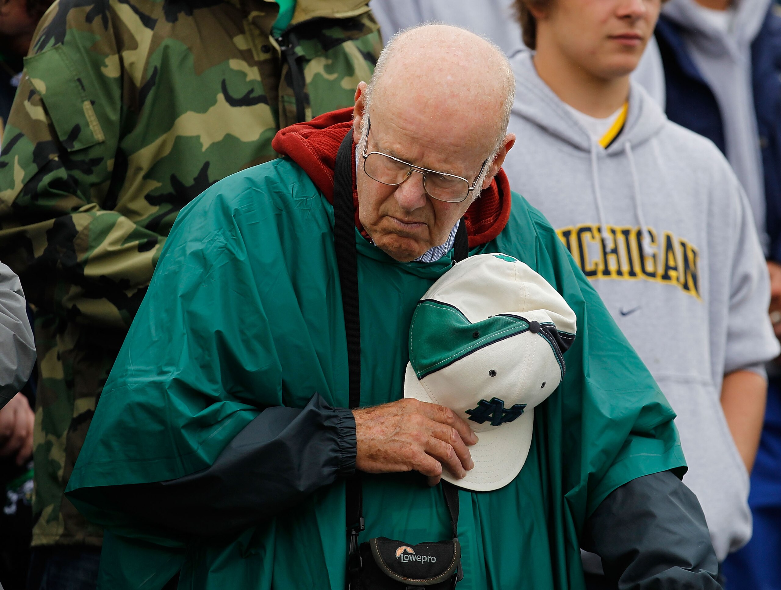 SOUTH BEND, IN - SEPTEMBER 11: A fan participates in a moment of silence commemorating the September 11, 2001 terrorist attacks before a game between the Notre Dame Fighting Irish and the Michigan Wolverines at Notre Dame Stadium on September 11, 2010 in