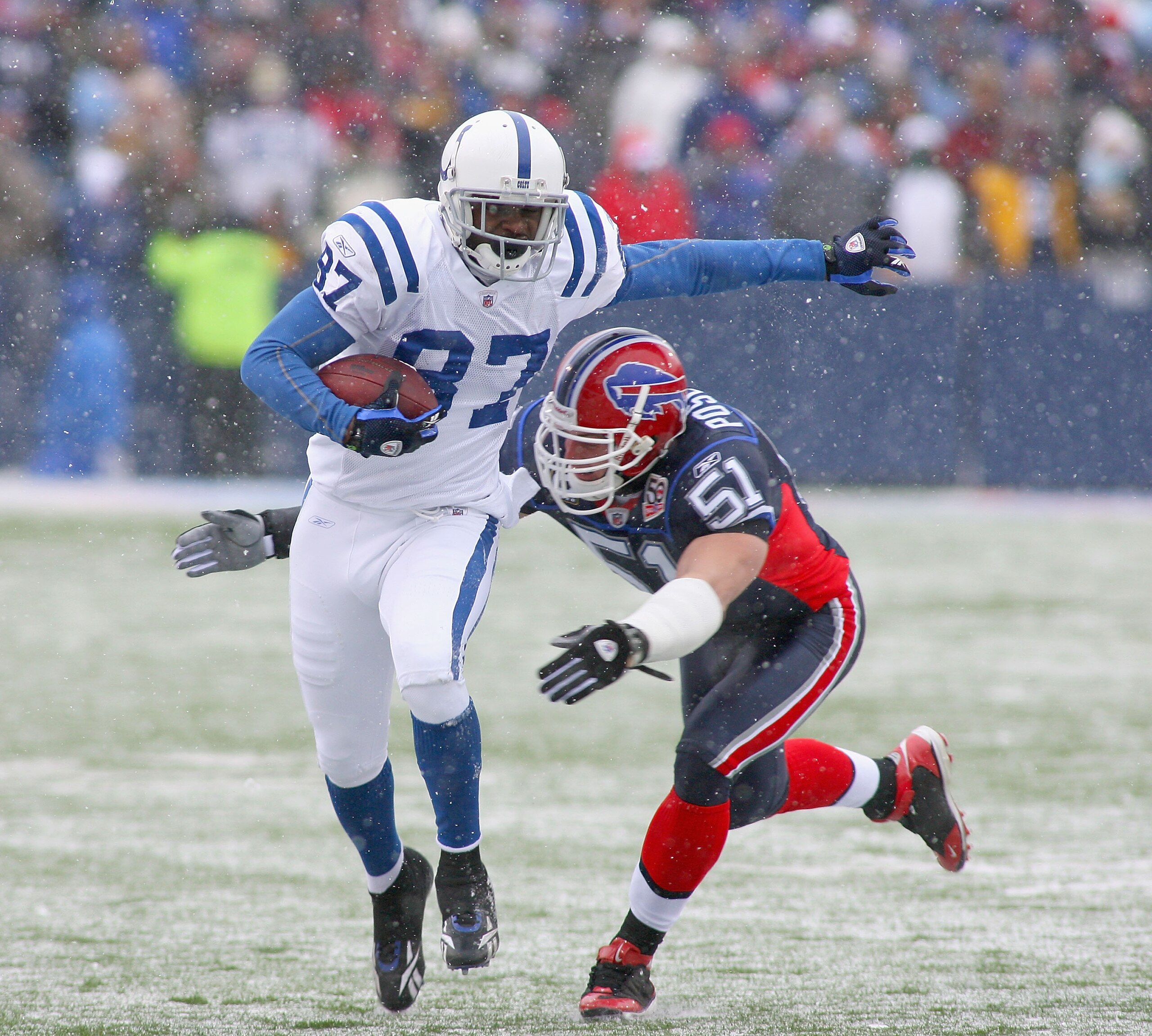 ORCHARD PARK, NY - JANUARY 03: Reggie Wayne #87  of the Indianapolis Colts runs after a catch as Paul Posluszny #51 of the Buffalo Bills comes in for the tackle at Ralph Wilson Stadium on January 3, 2010 in Orchard Park, New York.  (Photo by Rick Stewart/