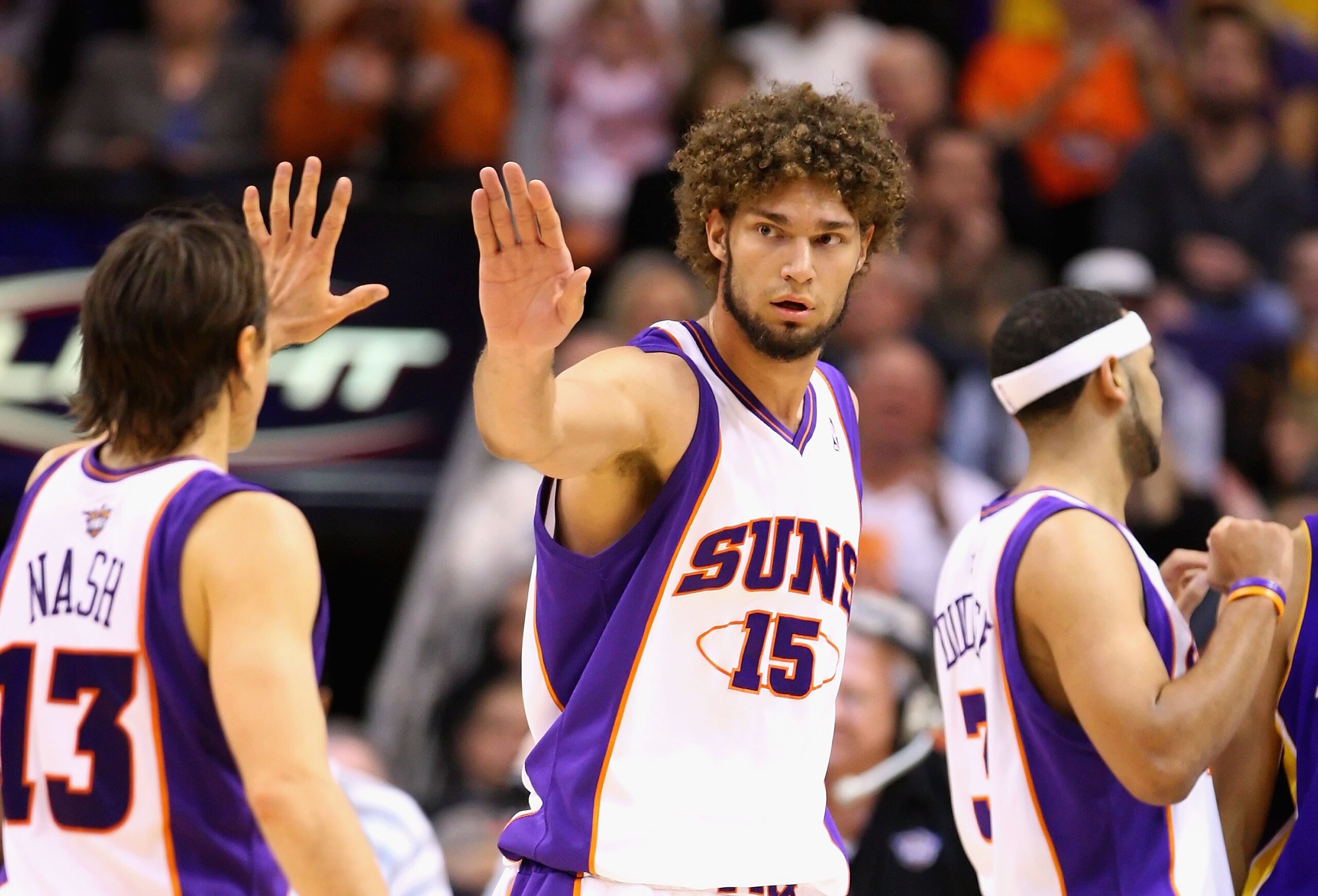 PHOENIX - DECEMBER 28:  Robin Lopez #15 and Steve Nash #13 of the Phoenix Suns high five during the NBA game against the Los Angeles Lakers at US Airways Center on December 28, 2009 in Phoenix, Arizona. The Suns defeated the Lakers 118-103. NOTE TO USER: