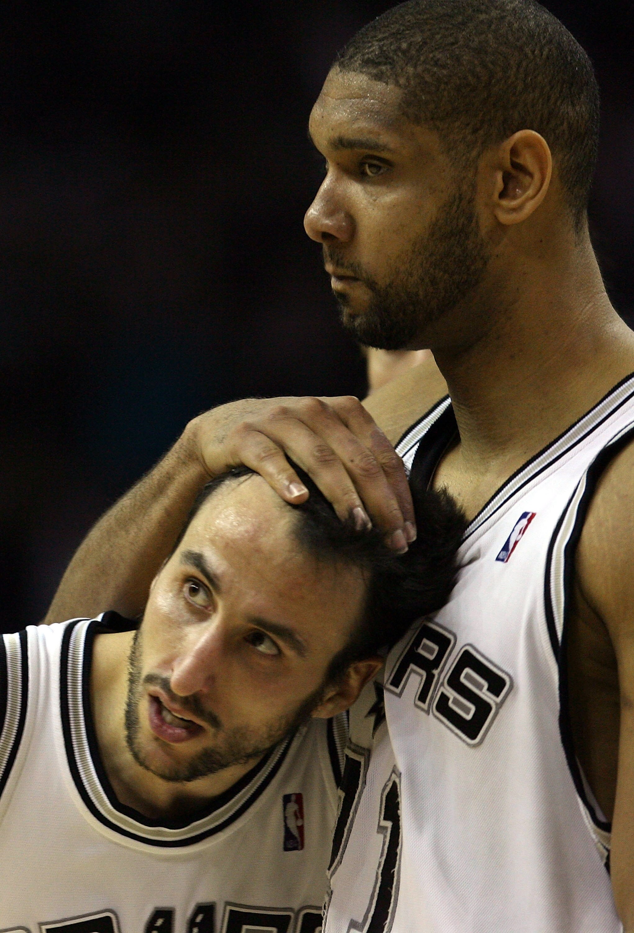 SAN ANTONIO - MAY 08:  Guard Manu Ginobili #20 is hugged by Tim Duncan #21 of the San Antonio Spurs after drawing the foul and making a three-point shot against the New Orleans Hornets in Game Three of the Western Conference Semifinals during the 2008 NBA