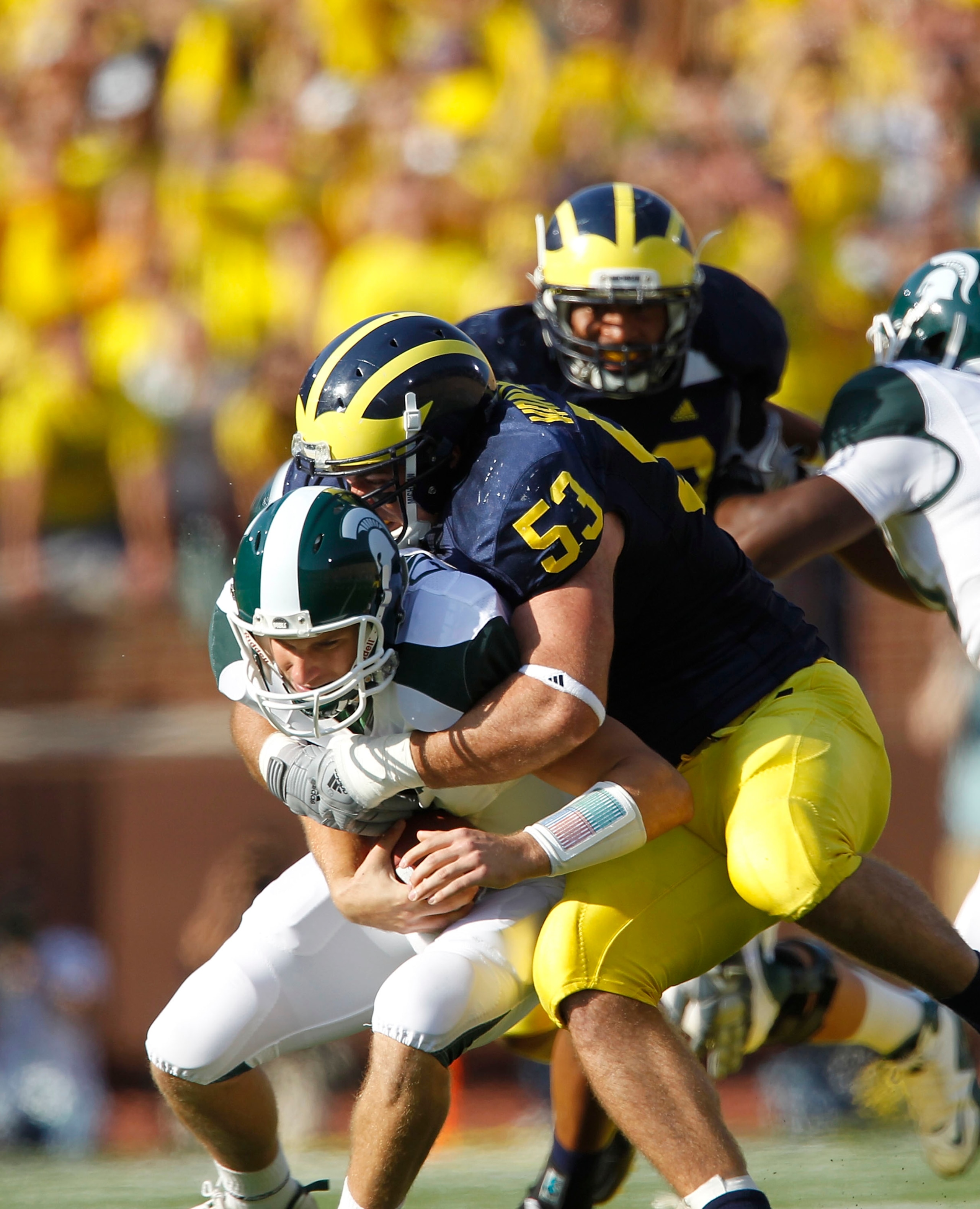 ANN ARBOR, MI - OCTOBER 09: Ryan Van Bergen #53 of the Michigan Wolverines sacks Kirk Cousins #8 of the Michigan State Spartans during the second quarter of the game on October 9, 2010 at Michigan Stadium in Ann Arbor, Michigan. (Photo by Leon Halip/Getty