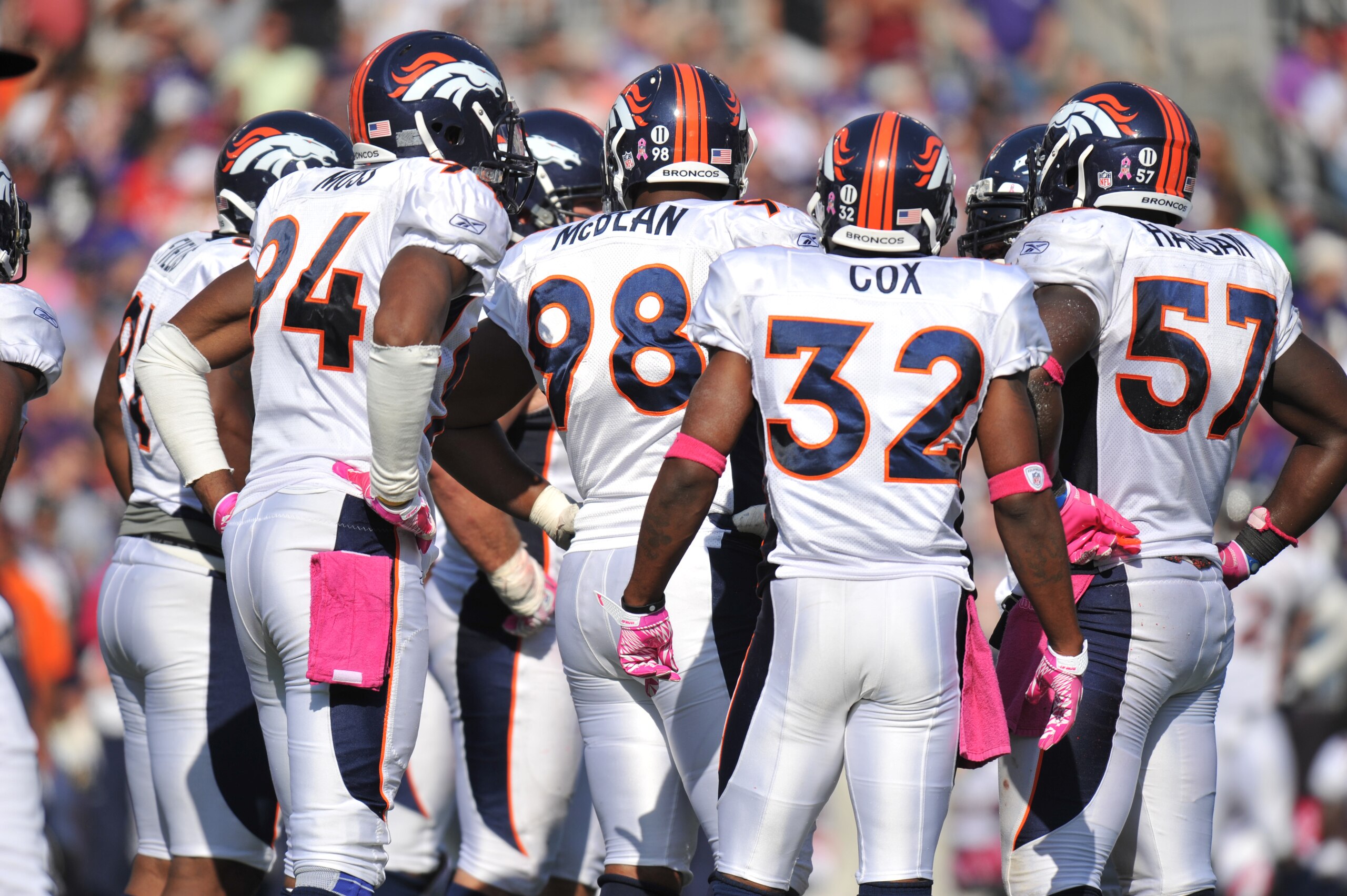 BALTIMORE, MD - OCTOBER 10: The Denver Broncos defense huddles during the game against the Baltimore Ravens at M&T Bank Stadium on October 10, 2010 in Baltimore, Maryland. Players wore pink in recognition of Breast Cancer Awareness Month. The Ravens defea BALTIMORE, MD - OCTOBER 10: The Denver Broncos defense huddles during the game against the Baltimore Ravens at M&T Bank Stadium on October 10, 2010 in Baltimore, Maryland. Players wore pink in recognition of Breast Cancer Awareness Month. The Ravens defea