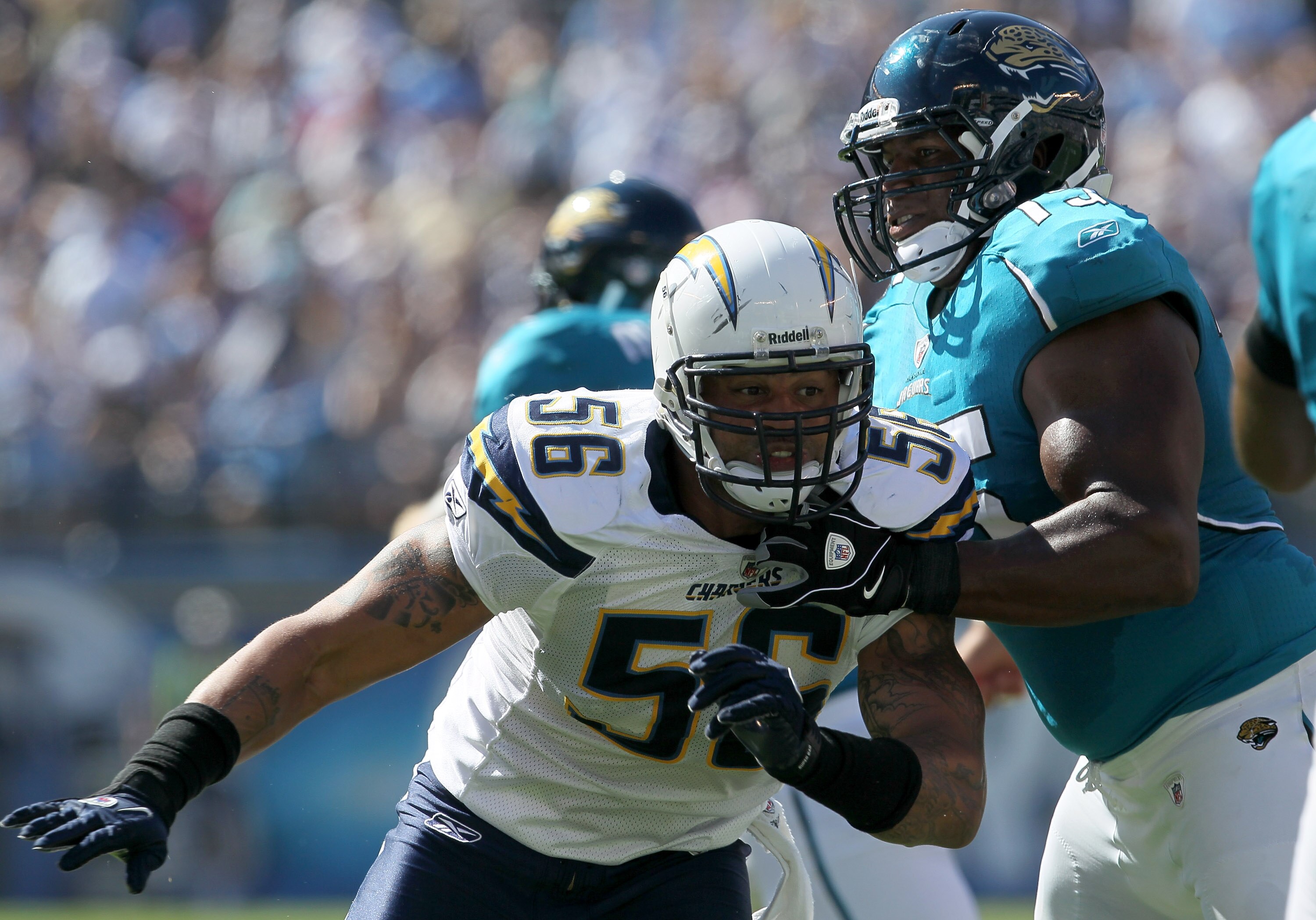 SAN DIEGO - SEPTEMBER 19:  Linebacker Shawne Merriman #56 of the San Diego Chargers fights against the block of tackle Eugene Monroe #75 of the Jacksonville Jaguars at Qualcomm Stadium on September 19, 2010 in San Diego, California. The Chargers won 38-13
