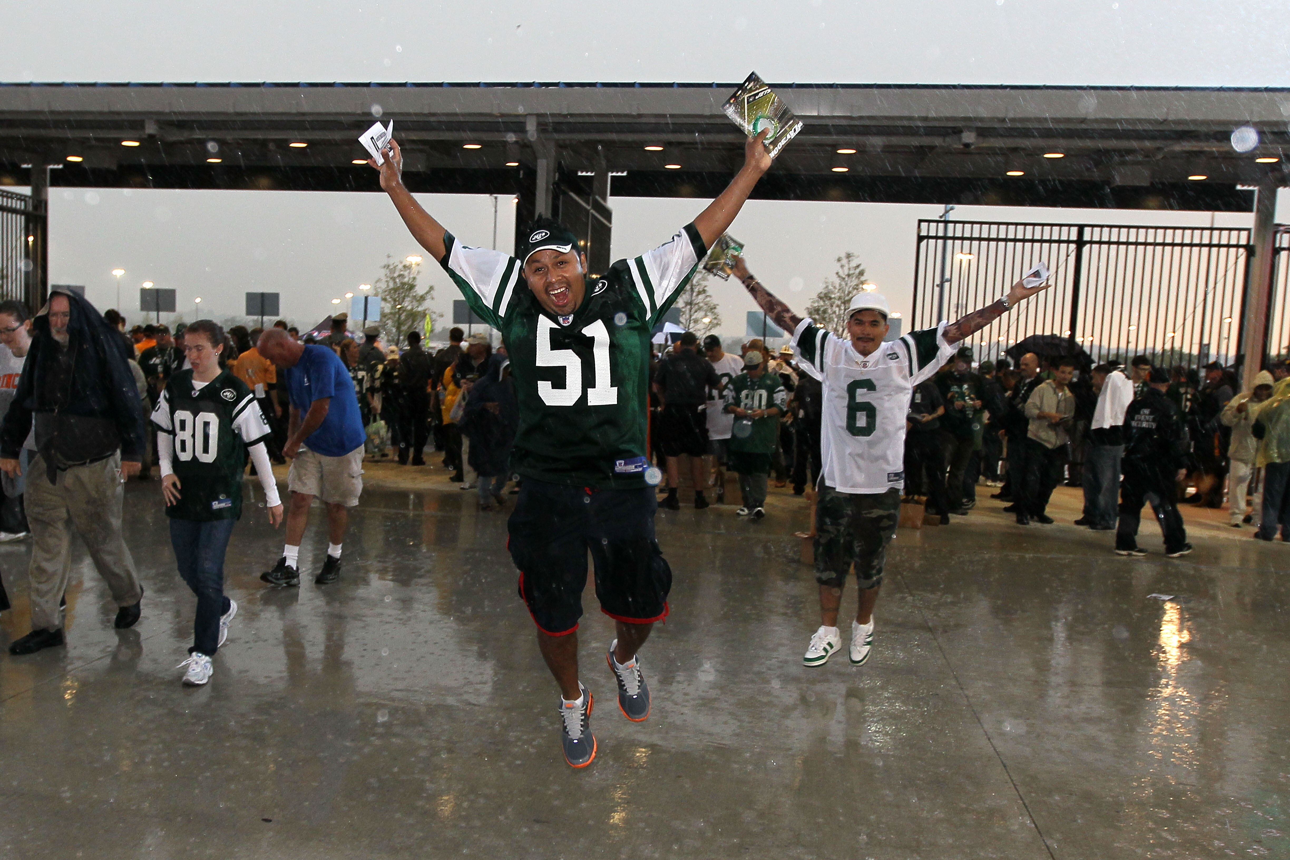 EAST RUTHERFORD, NJ - SEPTEMBER 13: Rain falls on Jets fans as they enter the west gate to watch the New York Jets play against the Baltimore Ravens prior to the home opener at the New Meadowlands Stadium on September 13, 2010 in East Rutherford, New Jers