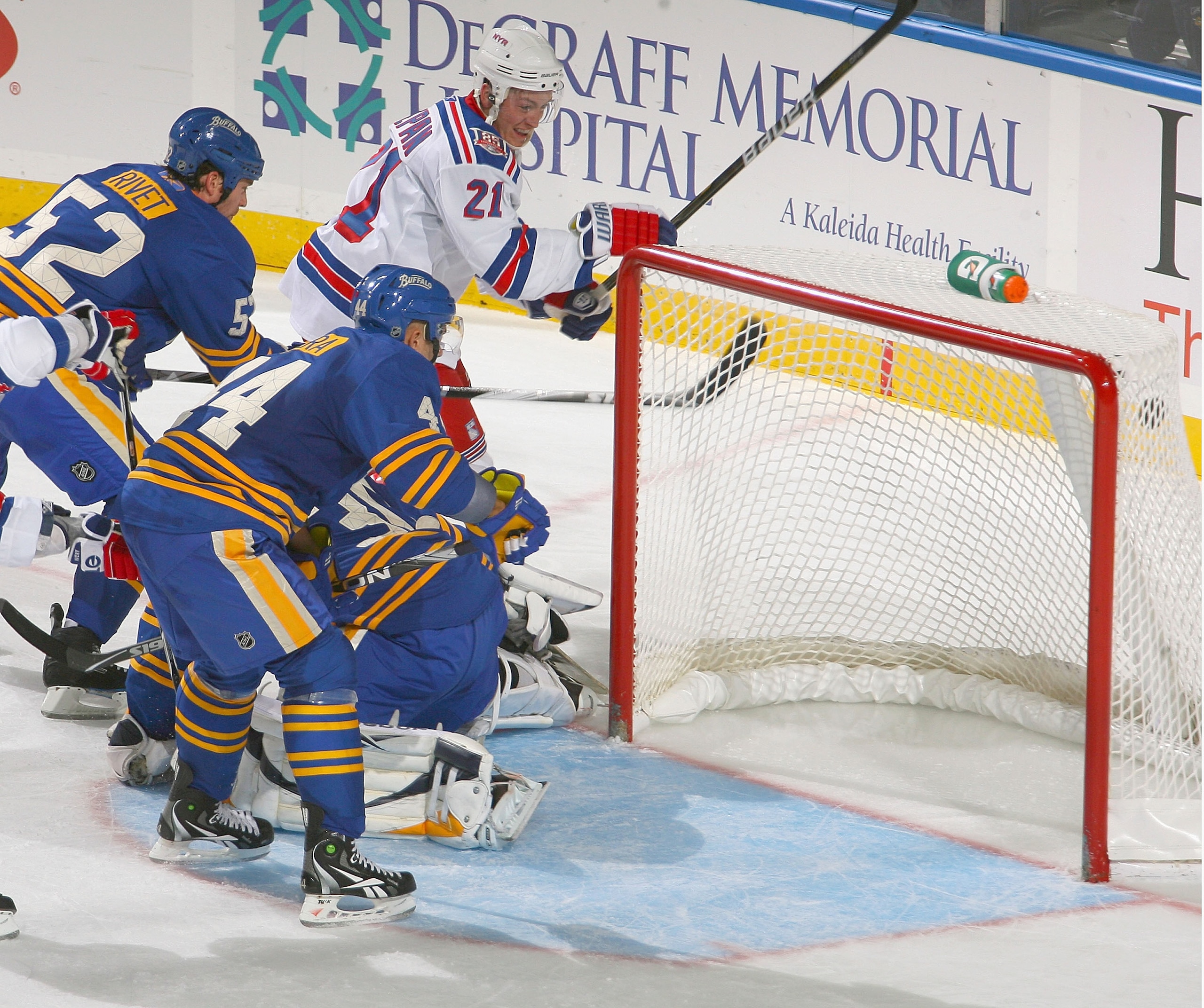BUFFALO, NY - OCTOBER 09: Derek Stepan #21 of the New York Rangers watches his shot hit the top corner of the net against Craig Rivet #52, Ryan  MIller #30 and Andrej Sekera #44 of the Buffalo Sabres  at HSBC Arena on October 9, 2010 in Buffalo, New York.