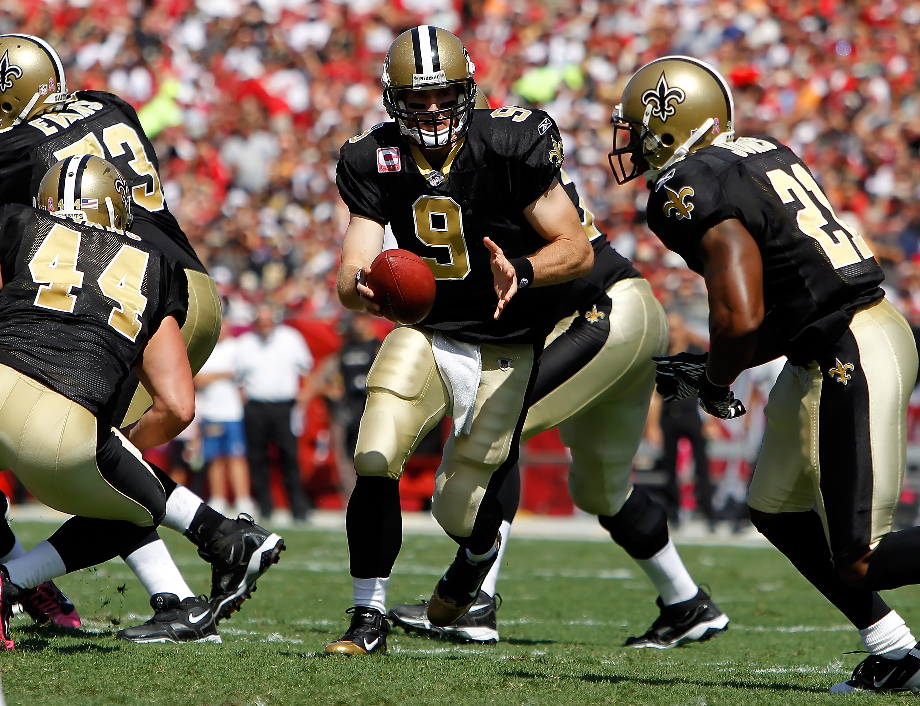 TAMPA, FL - OCTOBER 17: Quarterback Drew Brees #9 of the New Orleans Saints hands the ball off against the Tampa Bay Buccaneers during the game at Raymond James Stadium on October 17, 2010 in Tampa, Florida. (Photo by J. Meric/Getty Images) TAMPA, FL - OCTOBER 17: Quarterback Drew Brees #9 of the New Orleans Saints hands the ball off against the Tampa Bay Buccaneers during the game at Raymond James Stadium on October 17, 2010 in Tampa, Florida. (Photo by J. Meric/Getty Images)