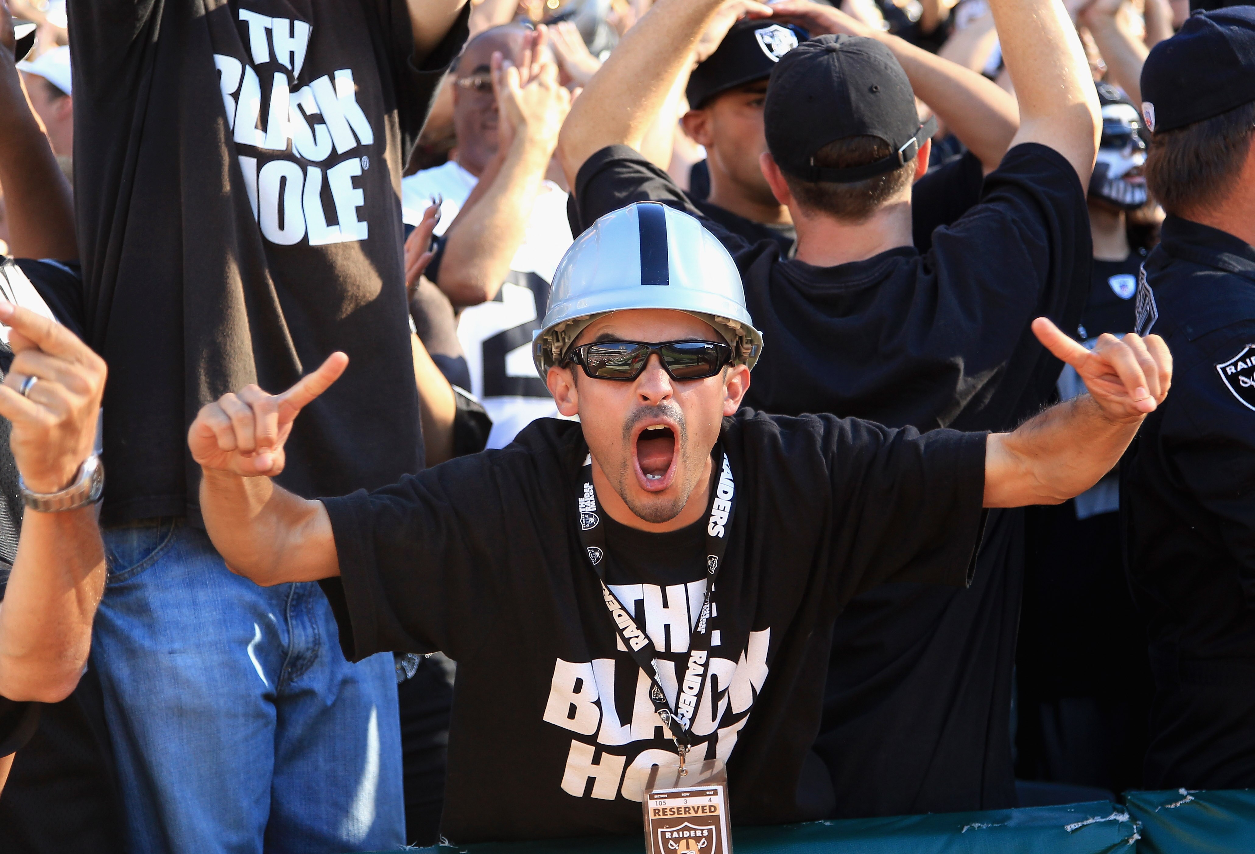OAKLAND, CA - OCTOBER 10:  An Oakland Raiders fan cheers on his team during their game against the San Diego Chargers at Oakland-Alameda County Coliseum on October 10, 2010 in Oakland, California.  (Photo by Ezra Shaw/Getty Images)
