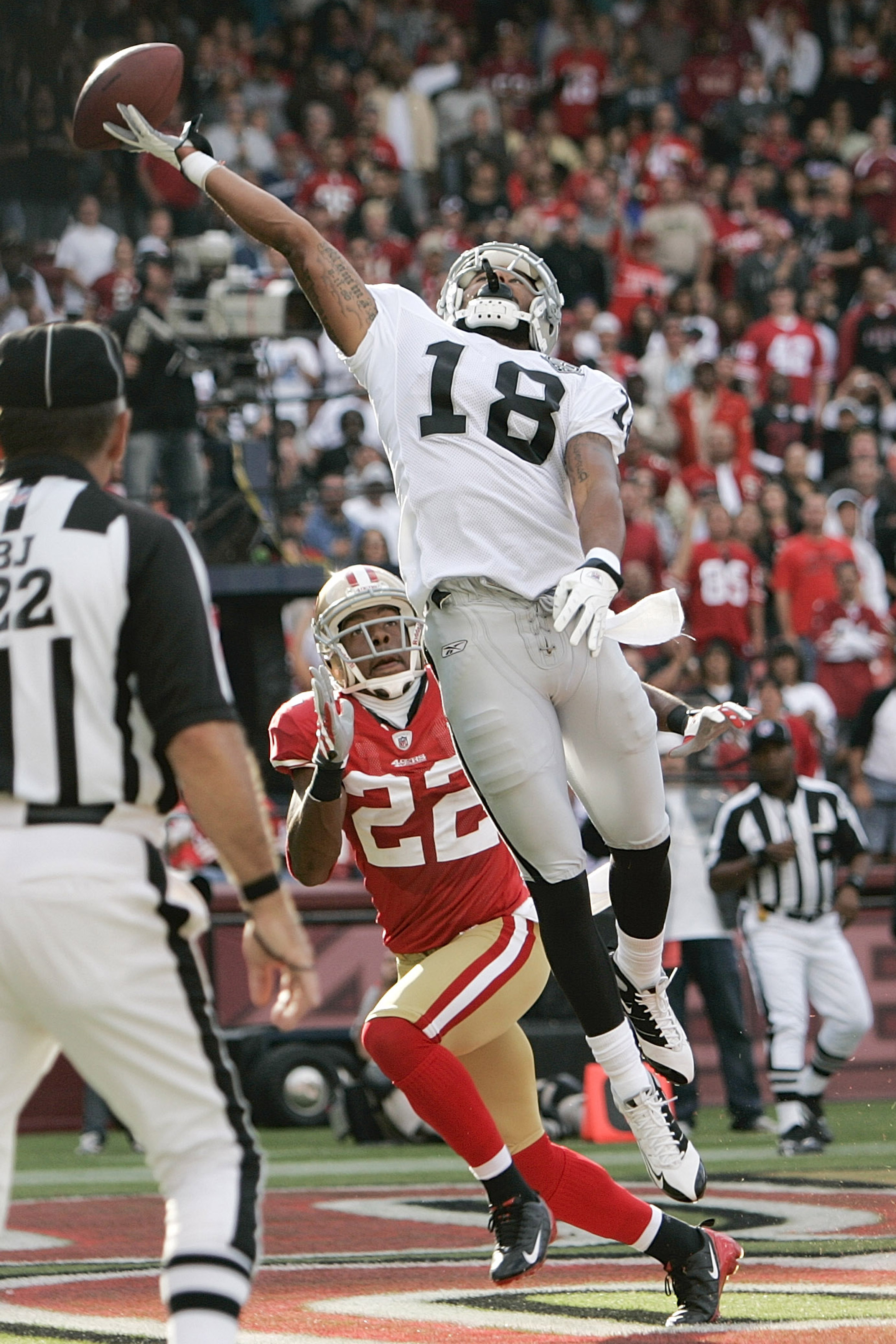 SAN FRANCISCO - AUGUST 22:   Oakland Raiders wide receiver Louis Murphy #18 tries to make a catch as San Francisco 49ers cornerback Nate Clements #22 defends in the 1st quarters as the San Francisco 49ers host the Oakland Raiders at Candlestick Park Augus