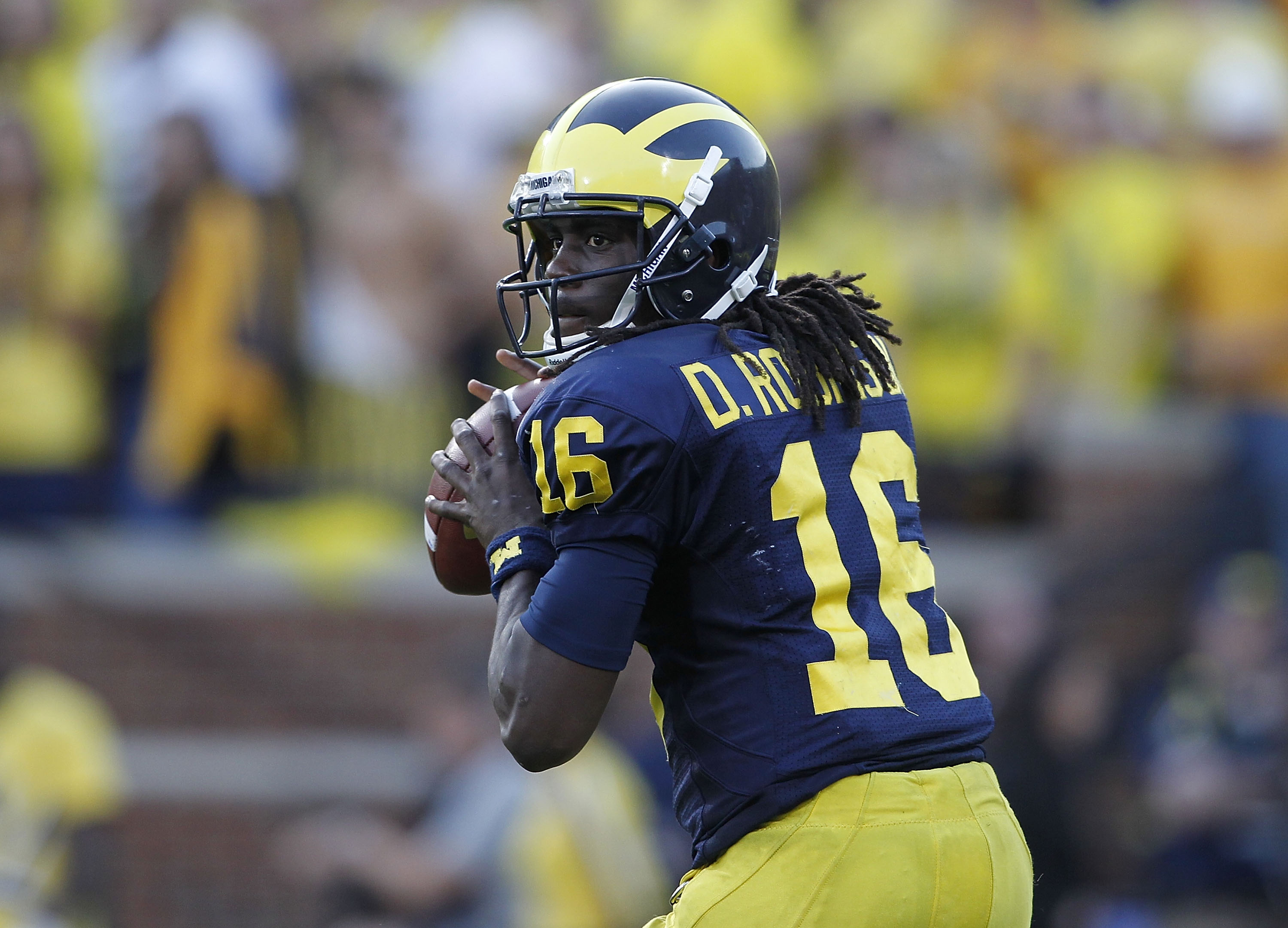 ANN ARBOR, MI - OCTOBER 09:  Denard Robinson #16 of the Michigan Wolverines drops back to pass during the game against the Michigan State Spartans on October 9, 2010 at Michigan Stadium in Ann Arbor, Michigan. The Michigan State Spartans defeated the Mich