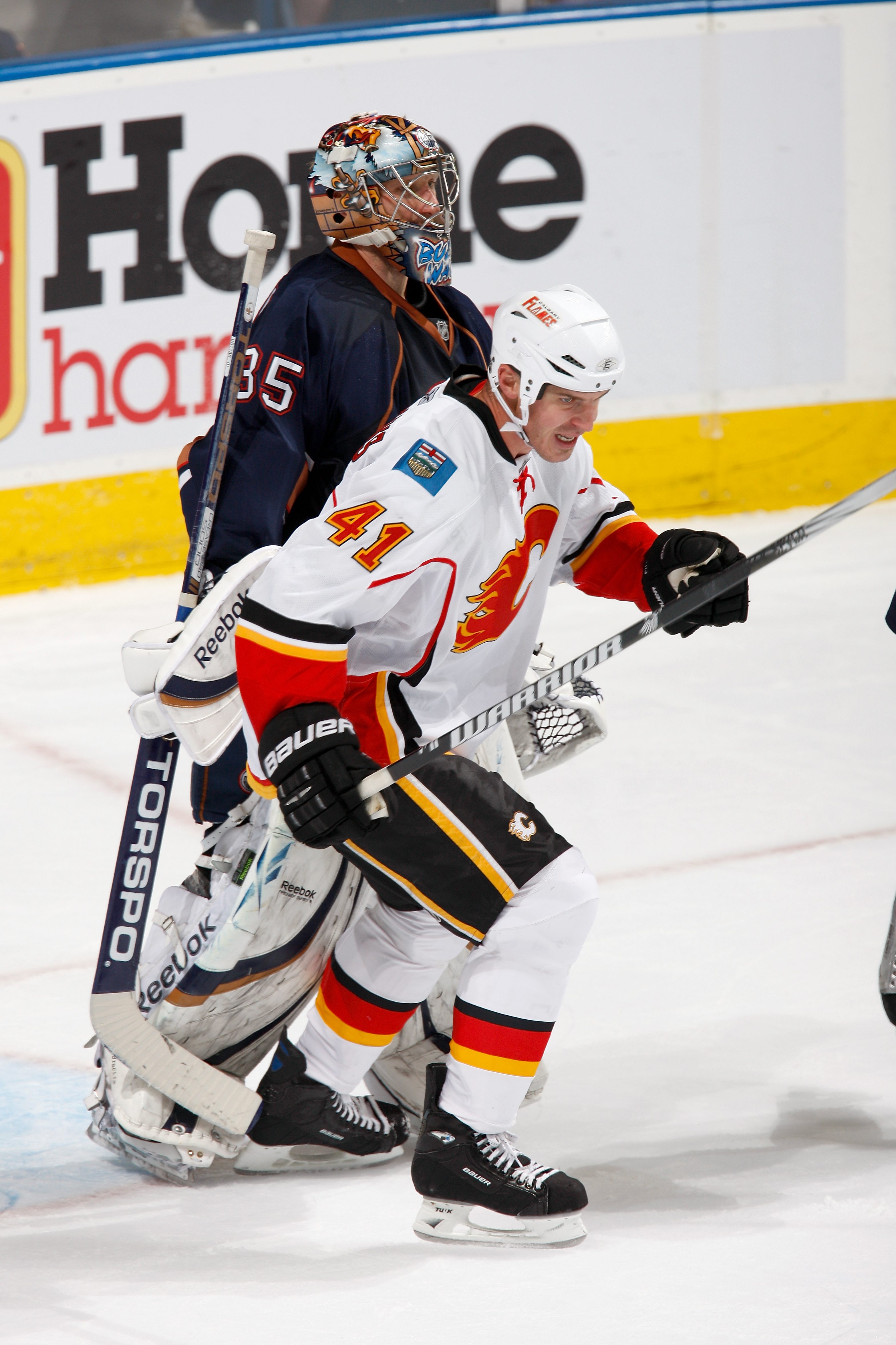 EDMONTON, CANADA - OCTOBER 1: Raitis Ivanans #41 of the Calgary Flames and Nikolai Khabibulin #35 of the Edmonton Oilers skates against the Calgary Flames on October 1, 2010 at Rexall Place in Edmonton, Alberta, Canada. (Photo by Dale MacMillan/Getty Imag