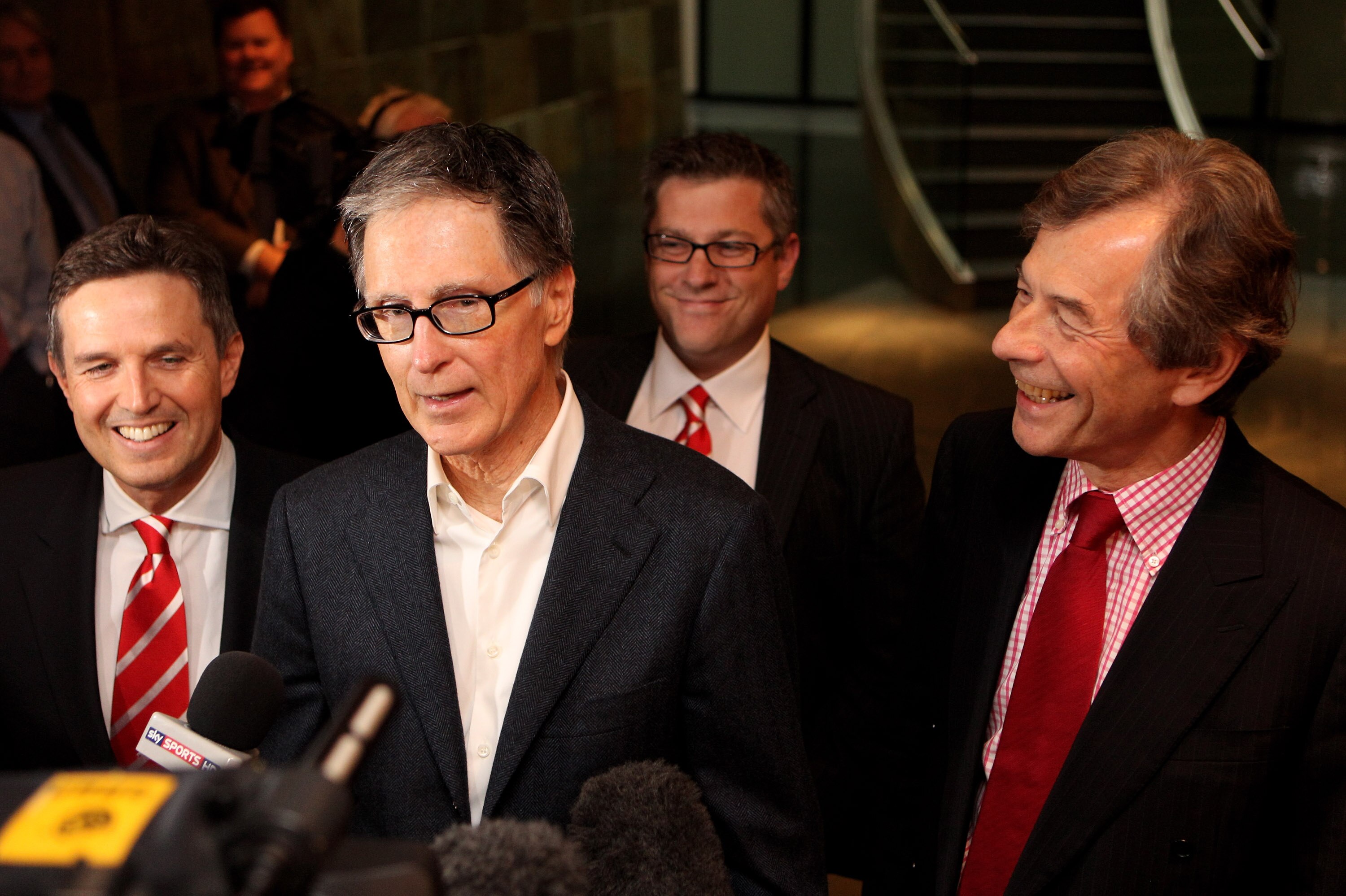 LONDON, ENGLAND - OCTOBER 15:  John W. Henry (Second Left), the owner of New England Sports Ventures, delivers a statement in the offices of the law firm Slaughter and May to announce his purchase of Liverpool Football Club with club chairman Martin Broug