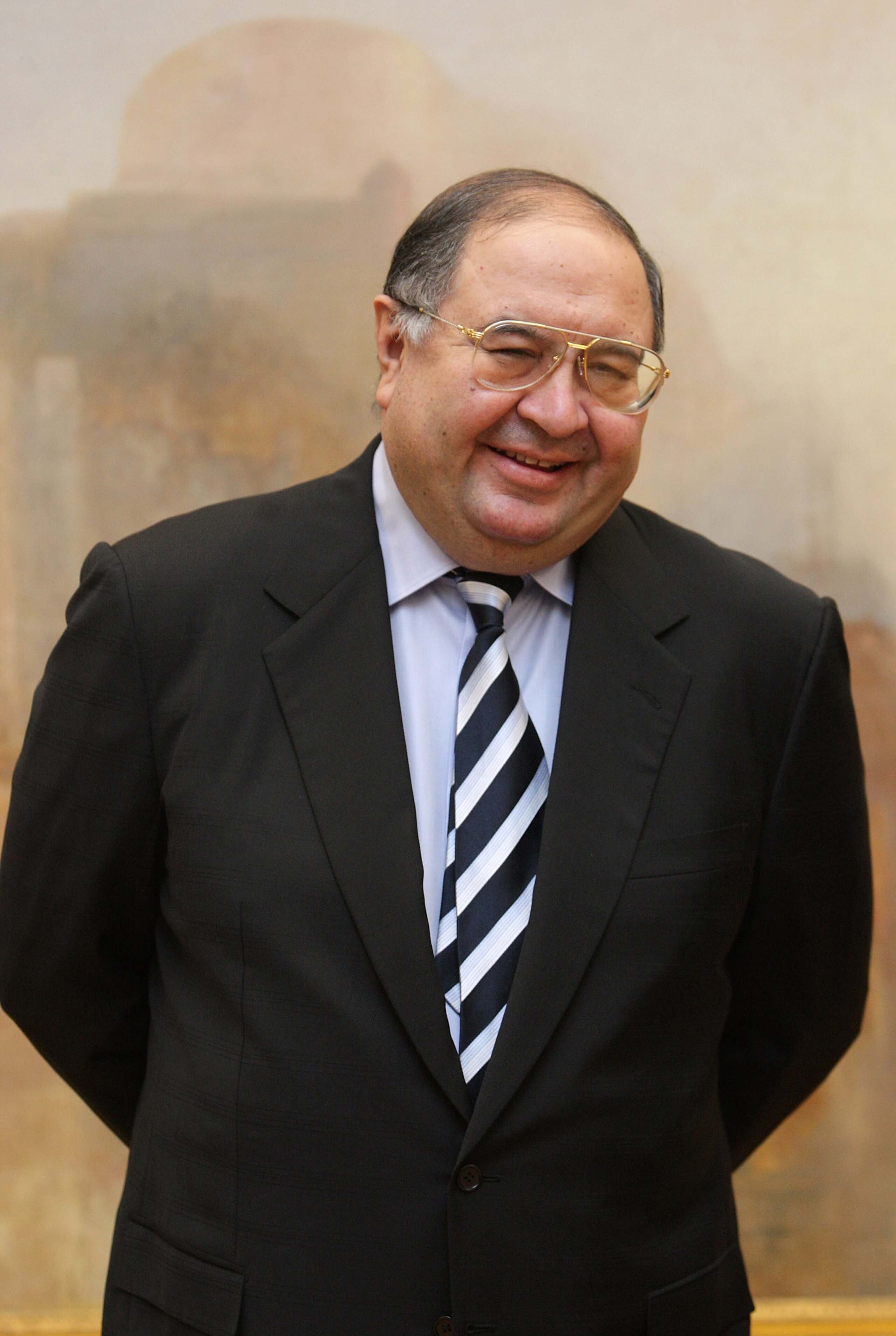 LONDON - NOVEMBER 07:  Russian oligarch Alisher Usmanov stands in front of JMW Turner's painting ' The Harbour of Brest ' in the Tate Britain art gallery  on November 7, 2008 in London, England. The Pushkin Museum in Moscow is hosting a major exhibition o