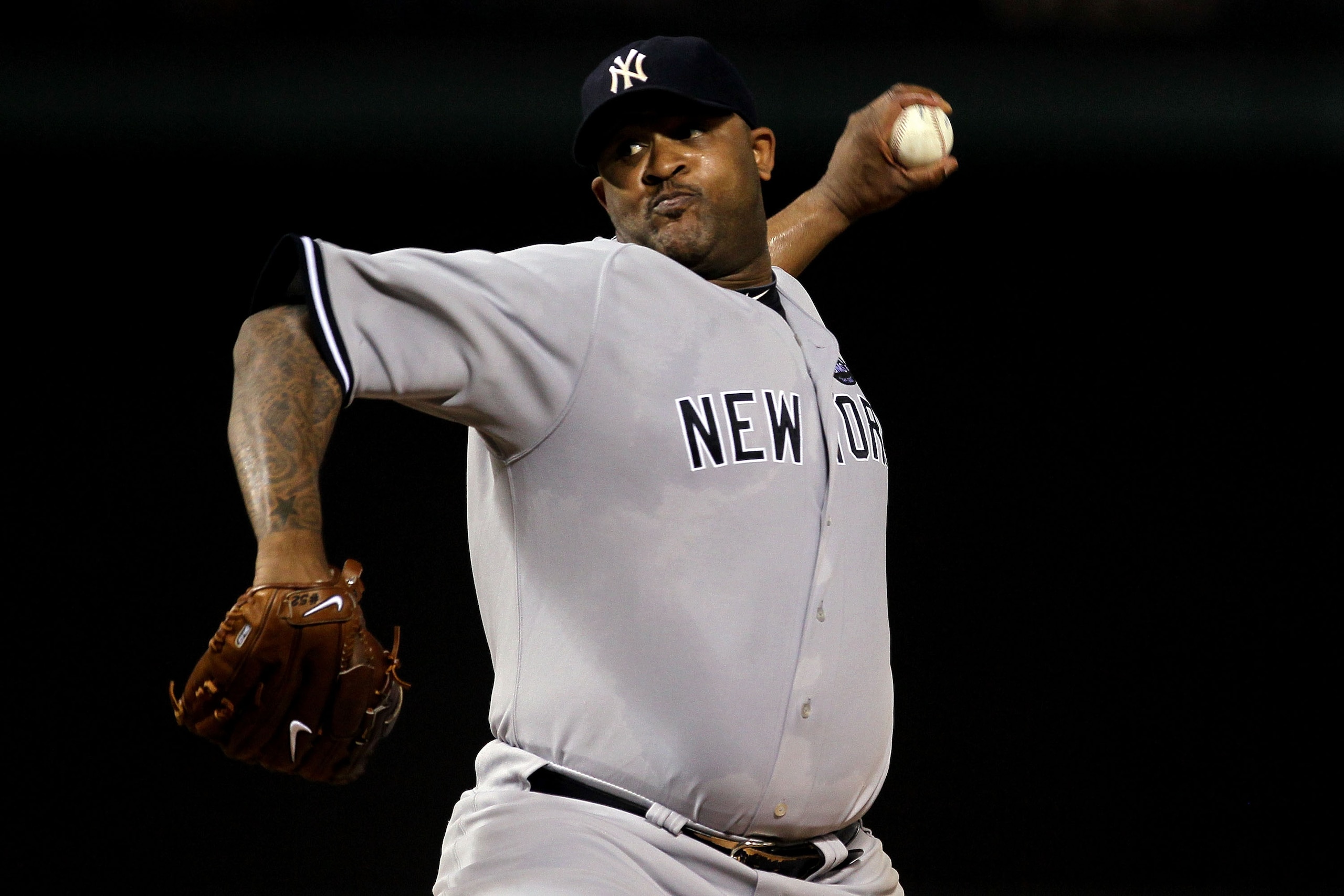 ARLINGTON, TX - OCTOBER 15:  CC Sabithia #52 of the New York Yankees throws a pitch against the Texas Rangers in Game One of the ALCS during the 2010 MLB Playoffs at Rangers Ballpark in Arlington on October 15, 2010 in Arlington, Texas.  (Photo by Stephen