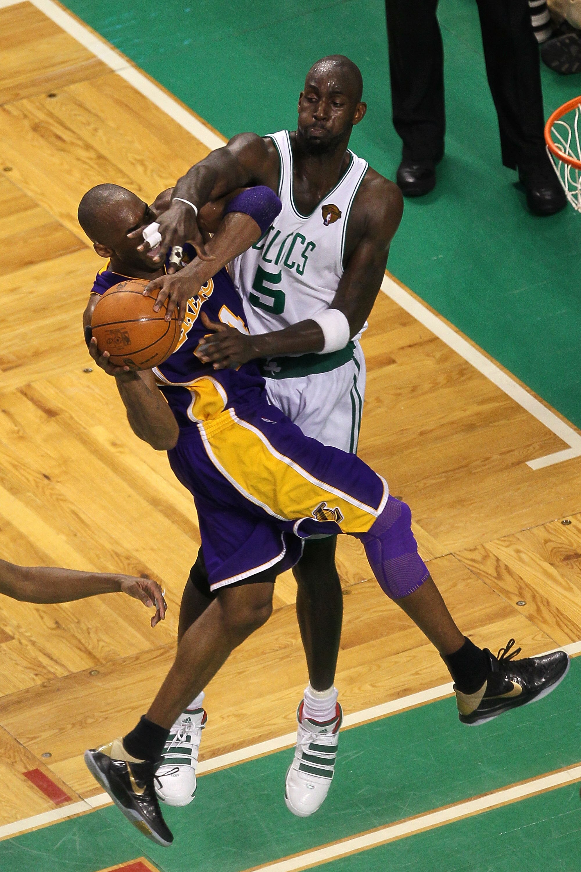 BOSTON - JUNE 13:  Kobe Bryant #24 of the Los Angeles Lakers goes to the basket under pressure against Kevin Garnett #5 of the Boston Celtics during Game Five of the 2010 NBA Finals on June 13, 2010 at TD Garden in Boston, Massachusetts. The Celtics won 9