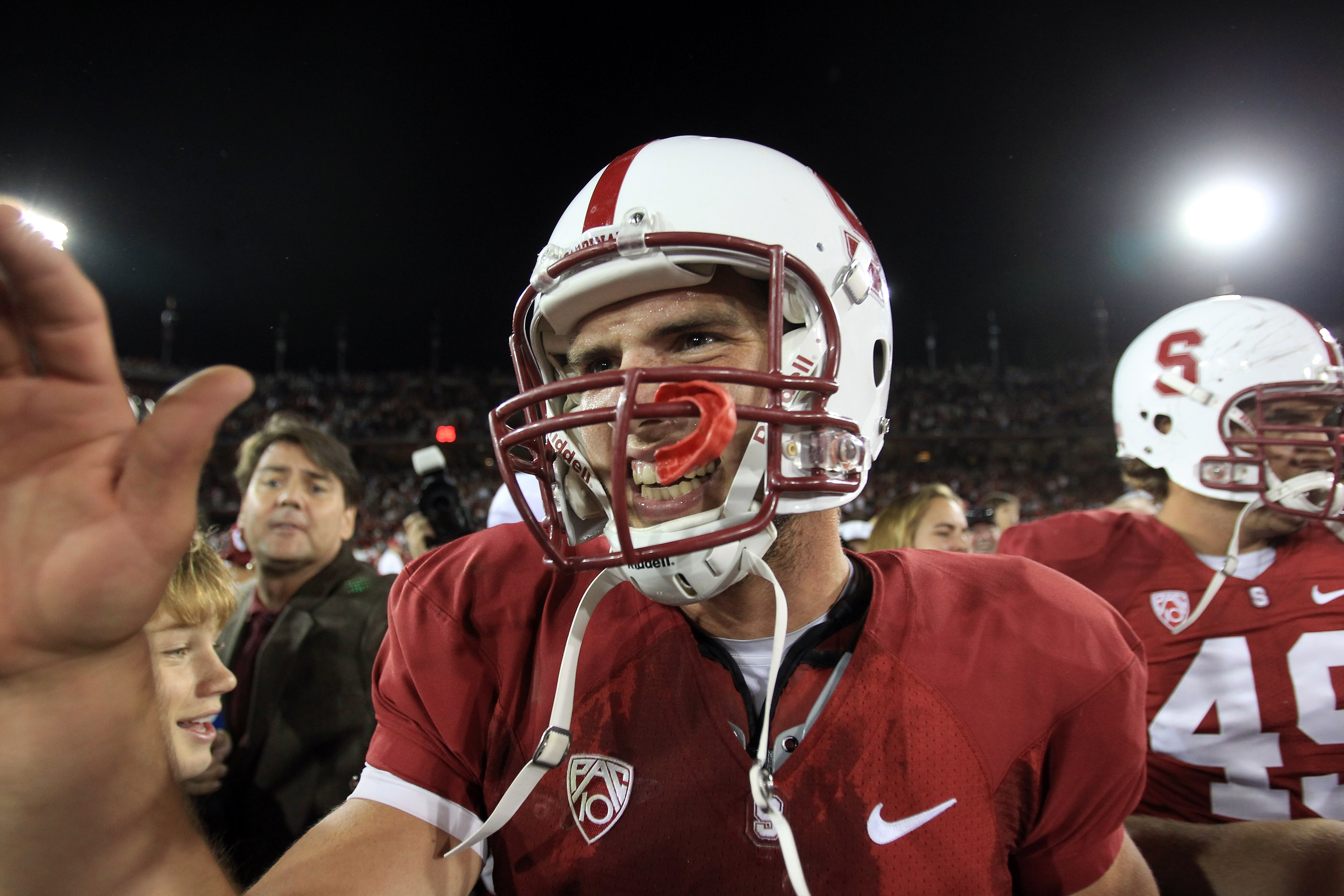PALO ALTO, CA - OCTOBER 09:  Andrew Luck #12 of the Stanford Cardinal is surrounded by teammates and fans after they beat the USC Trojans 37-35 at Stanford Stadium on October 9, 2010 in Palo Alto, California.  (Photo by Ezra Shaw/Getty Images)