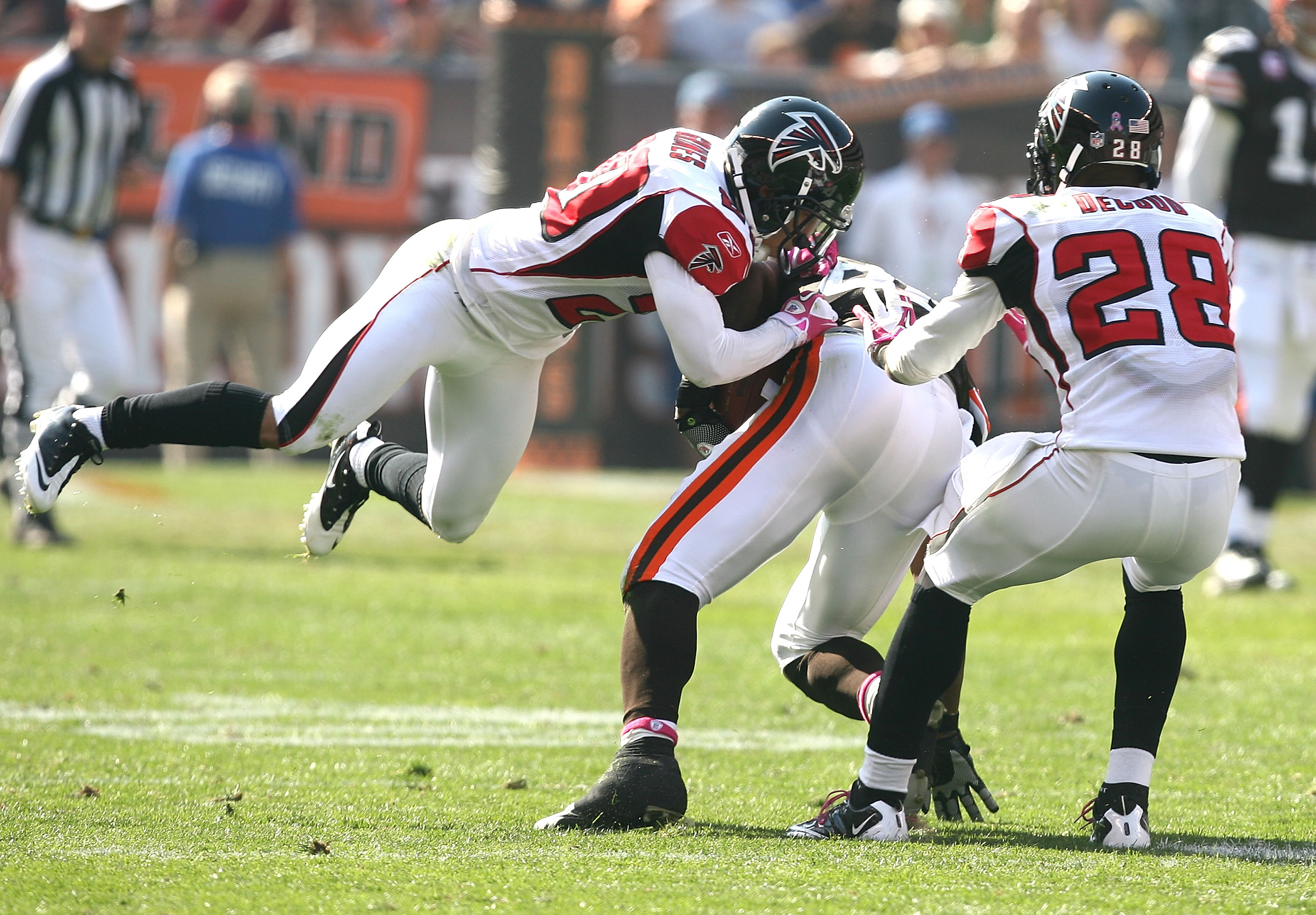 CLEVELAND - OCTOBER 10:  Tight end Benjamin Watson #82 of the Cleveland Browns is tackled by defenders Brent Grimes #20 and Thomas DeCoud #28 of the Atlanta Falcons at Cleveland Browns Stadium on October 10, 2010 in Cleveland, Ohio.  (Photo by Matt Sulliv