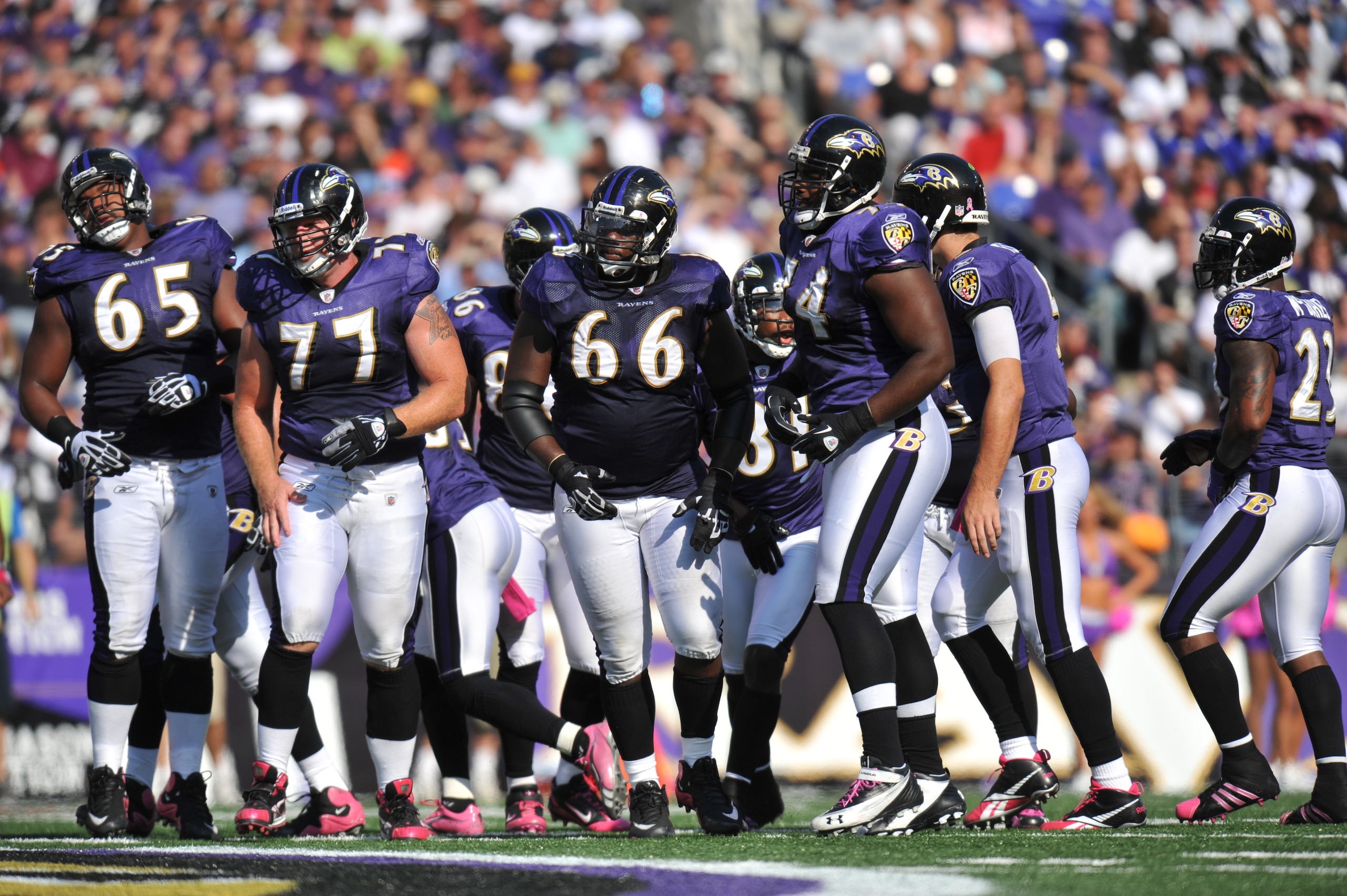 BALTIMORE, MD - OCTOBER 10: The Baltimore Ravens offensive line walks up to the line of scrimmage during the game against the Denver Broncos at M&T Bank Stadium on October 10, 2010 in Baltimore, Maryland. Players wore pink in recognition of Breast Cancer