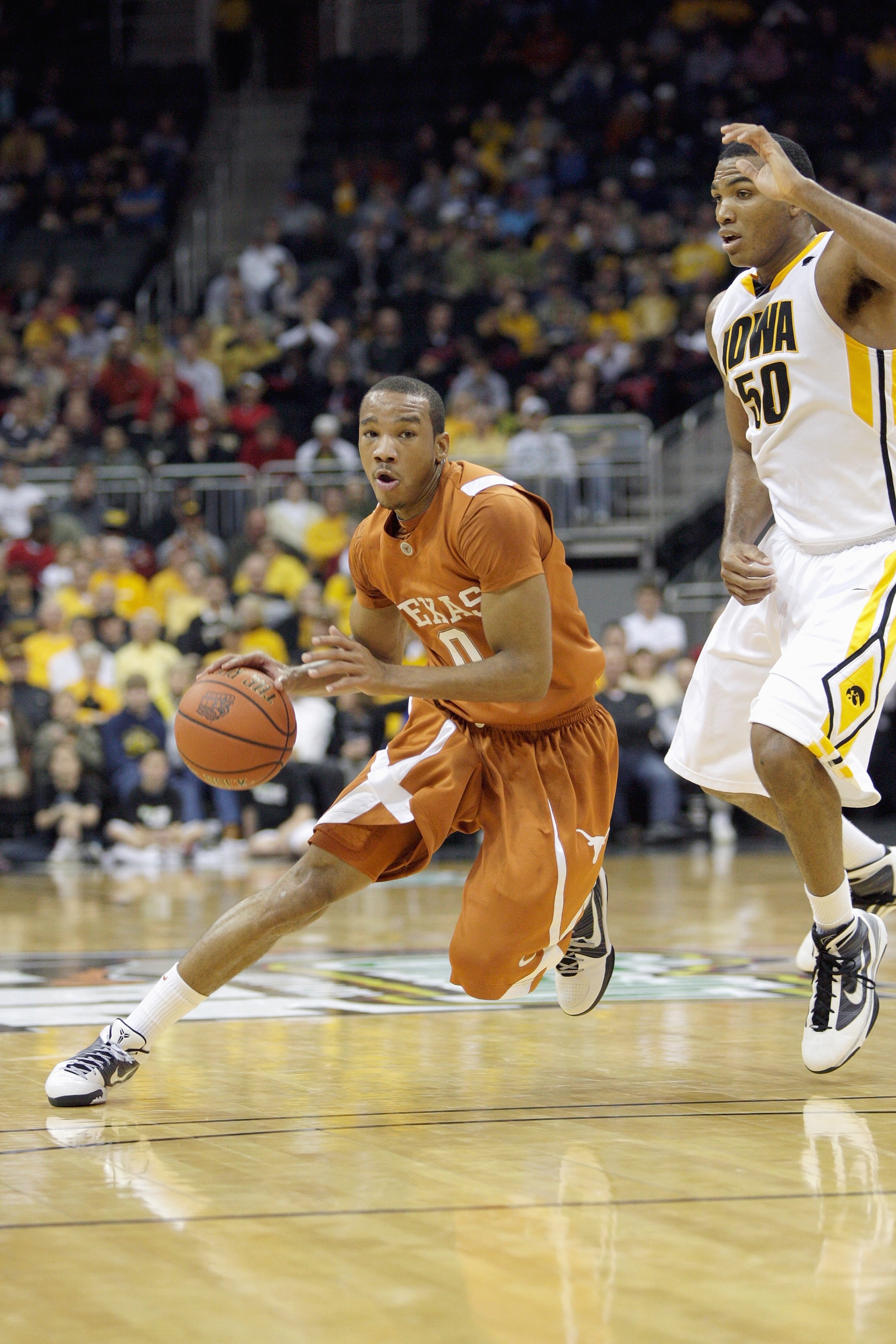 KANSAS CITY, MO - NOVEMBER 23:  Avery Bradley #0 of the Texas Longhorns dribbles the ball against Jarryd Cole #50 of the Iowa Hawkeyes during the CBE Classic semifinal game on November 23, 2009 at Sprint Center in Kansas City, Missouri. (Photo by: Jamie S