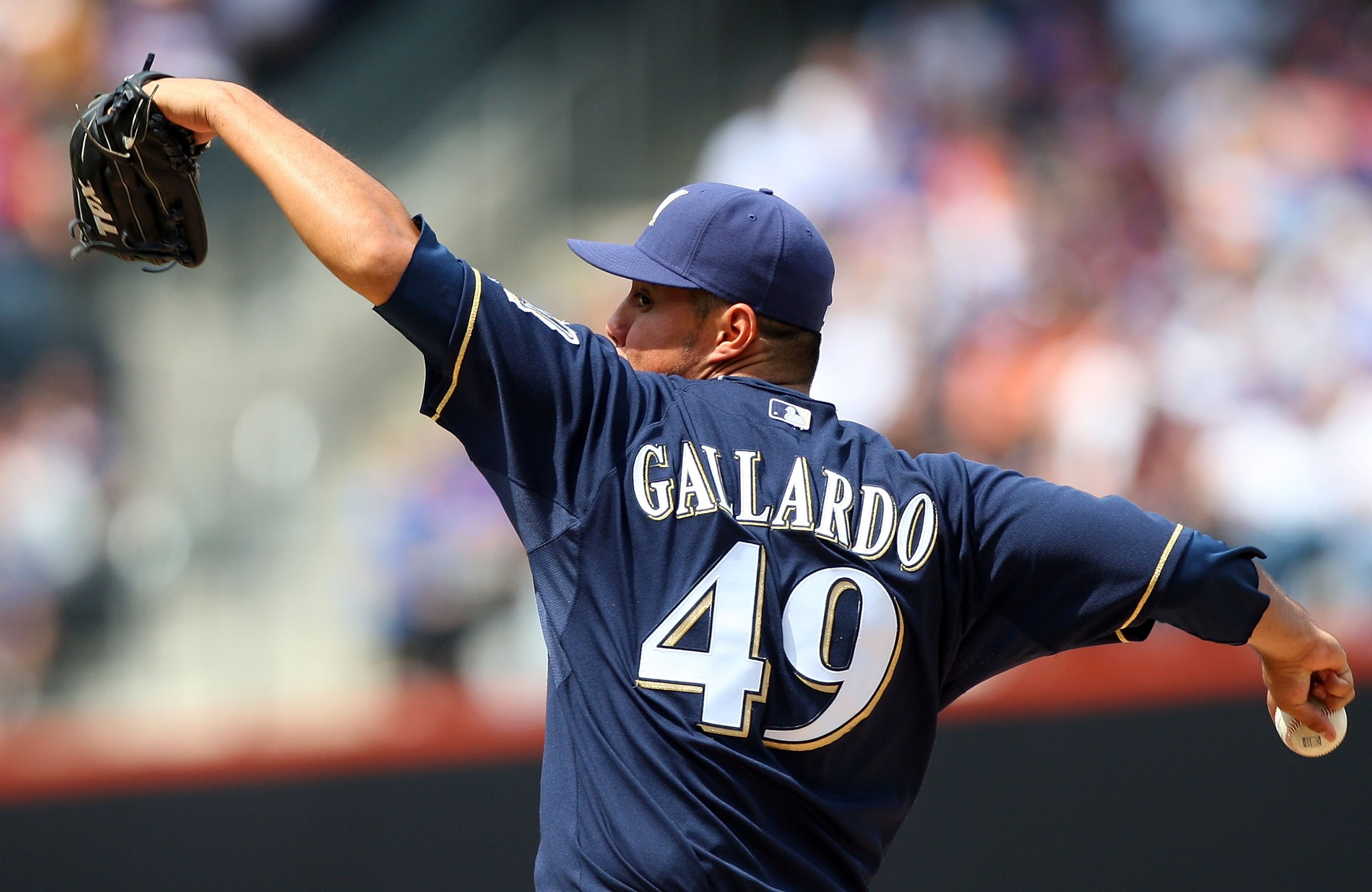 NEW YORK - APRIL 18:  Yovani Gallardo #49 of the Milwaukee Brewers deals a pitch against the New York Mets on April 18, 2009 at Citi Field in the Flushing neighborhood of the Queens borough of New York City.  (Photo by Jim McIsaac/Getty Images)