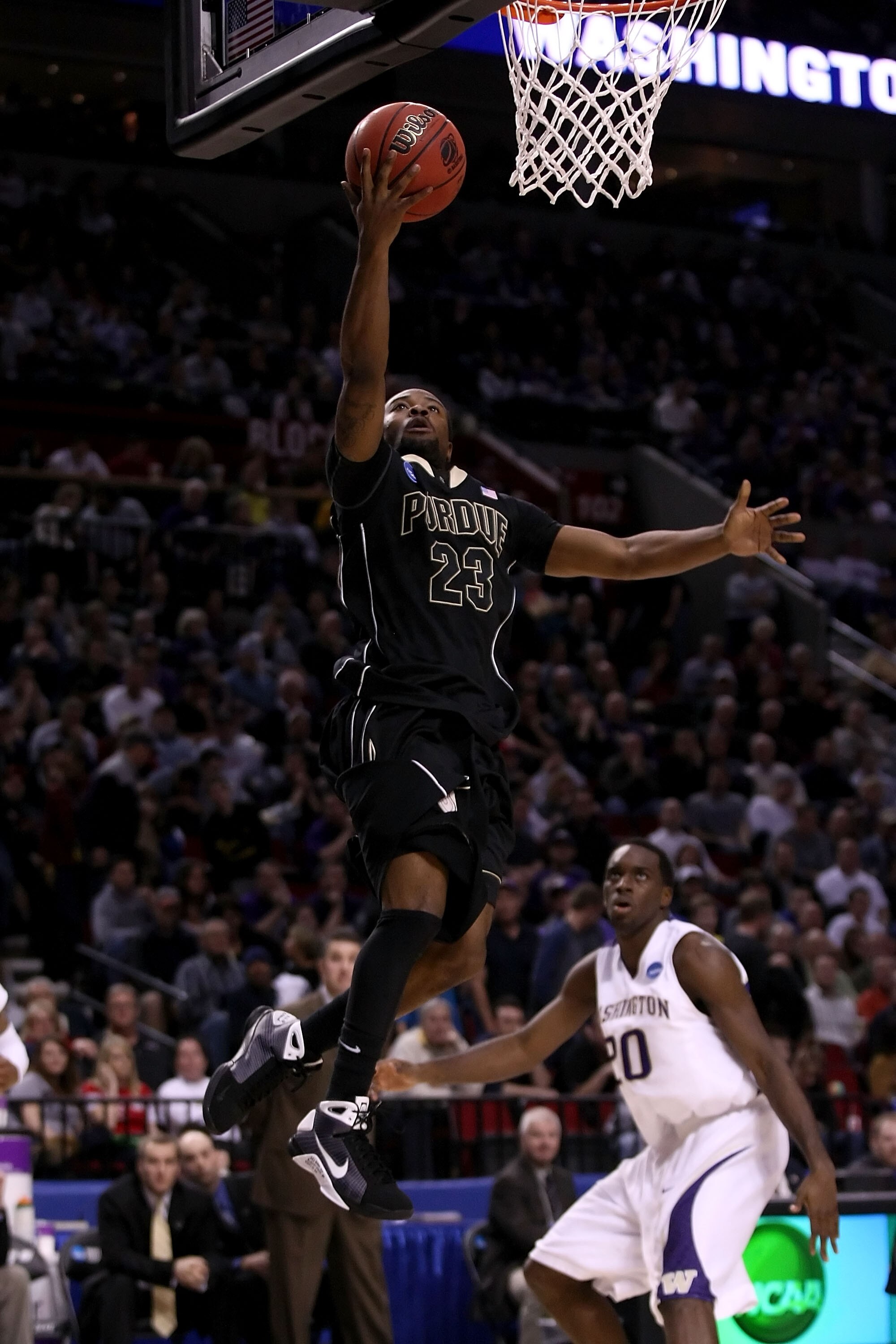PORTLAND, OR - MARCH 21:  Lewis Jackson #23 of the Purdue Boilermakers goes up for a layup as Quincy Pondexter #20 of the Washington Huskies looks on during the second round of the NCAA Division I Men's Basketball Tournament at the Rose Garden on March 21