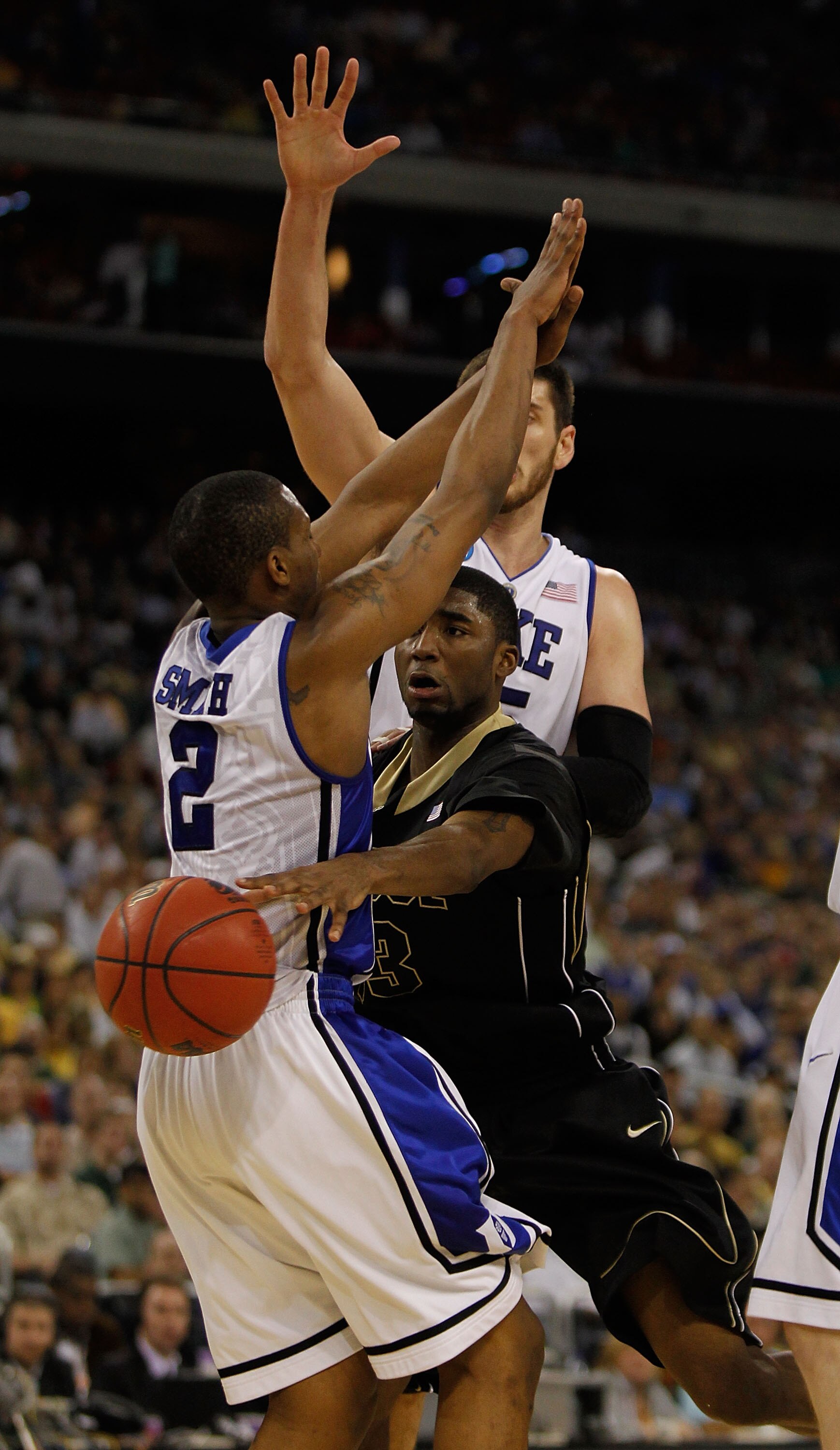 HOUSTON - MARCH 26: E'Twaun Moore #33 of the Purdue Boilermakers passes around Nolan Smith #2 of the Duke Blue Devils during the south regional semifinal of the 2010 NCAA men's basketball tournament at Reliant Stadium on March 26, 2010 in Houston, Texas. 