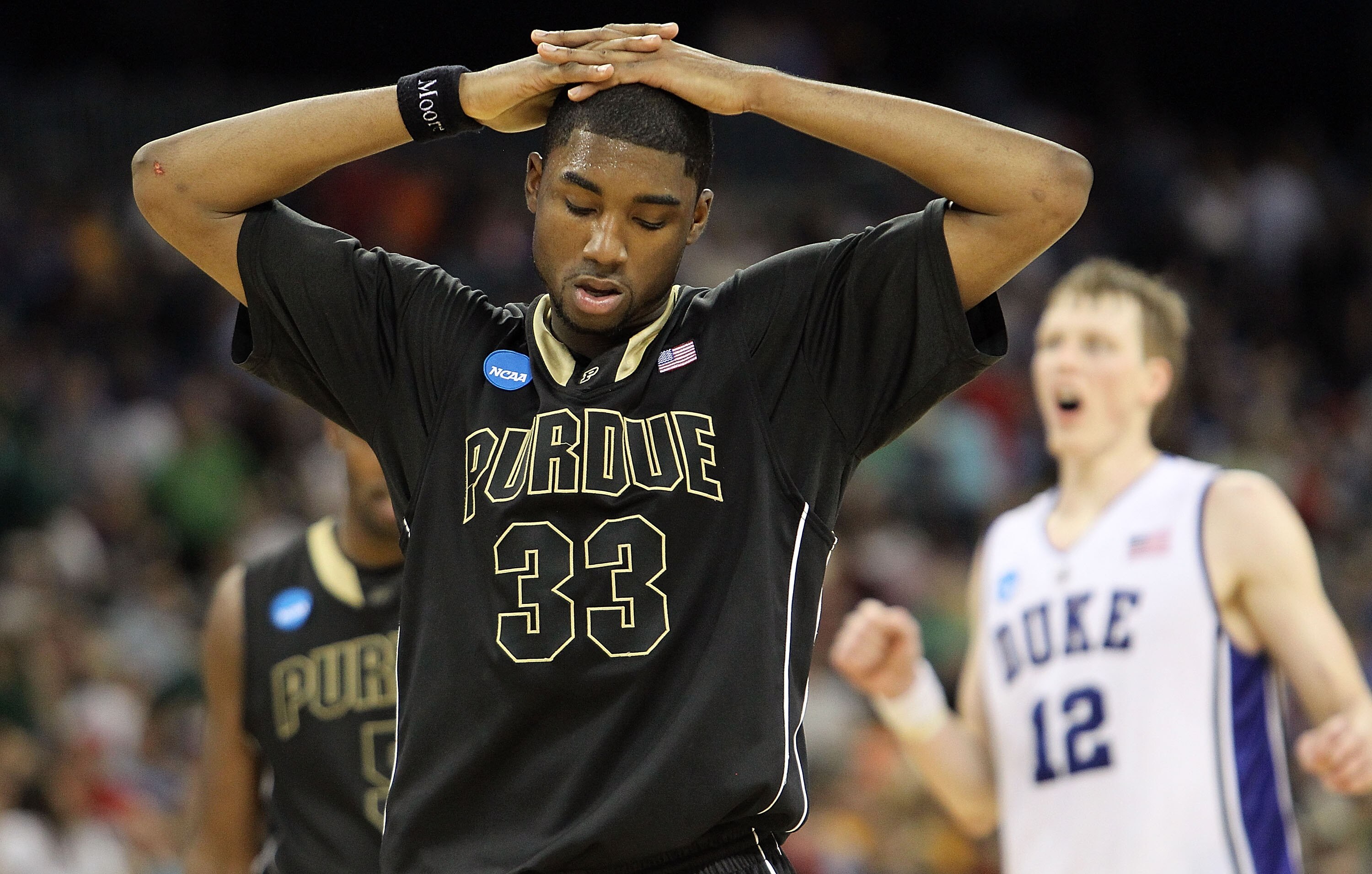 HOUSTON - MARCH 26: E'Twaun Moore #33 of the Purdue Boilermakers reacts in a 70-57 loss against the Duke Blue Devils during the south regional semifinal of the 2010 NCAA men's basketball tournament at Reliant Stadium on March 26, 2010 in Houston, Texas. (