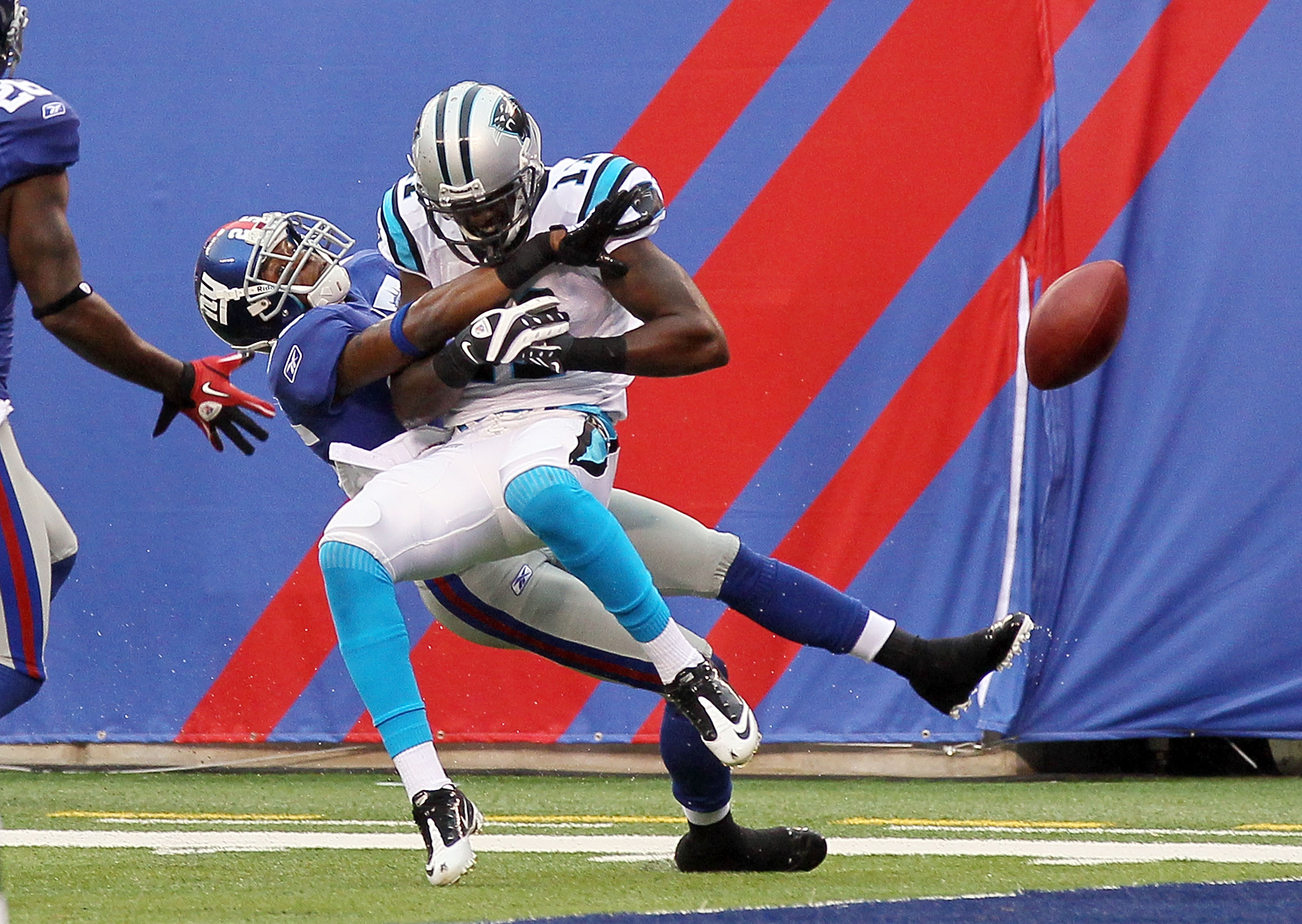 EAST RUTHERFORD, NJ - SEPTEMBER 12:  Bruce Johnson #25 of the New York Giants is called for pas interference against Brandon LaFell #11 of the Carolina Panthers on September 12, 2010 at the New Meadowlands Stadium in East Rutherford, New Jersey. The Giant