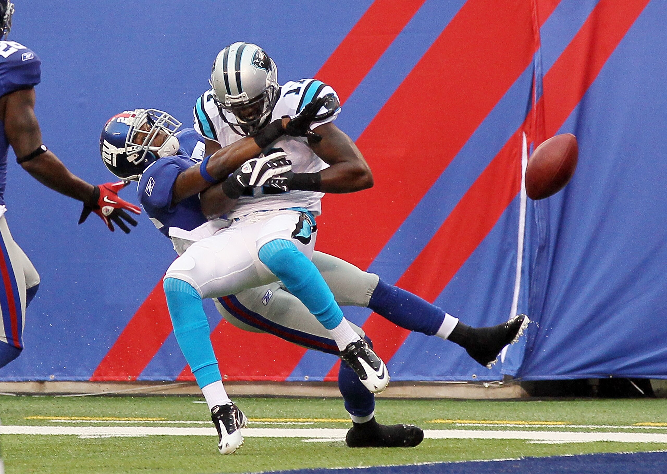 EAST RUTHERFORD, NJ - SEPTEMBER 12:  Bruce Johnson #25 of the New York Giants is called for pas interference against Brandon LaFell #11 of the Carolina Panthers on September 12, 2010 at the New Meadowlands Stadium in East Rutherford, New Jersey. The Giant
