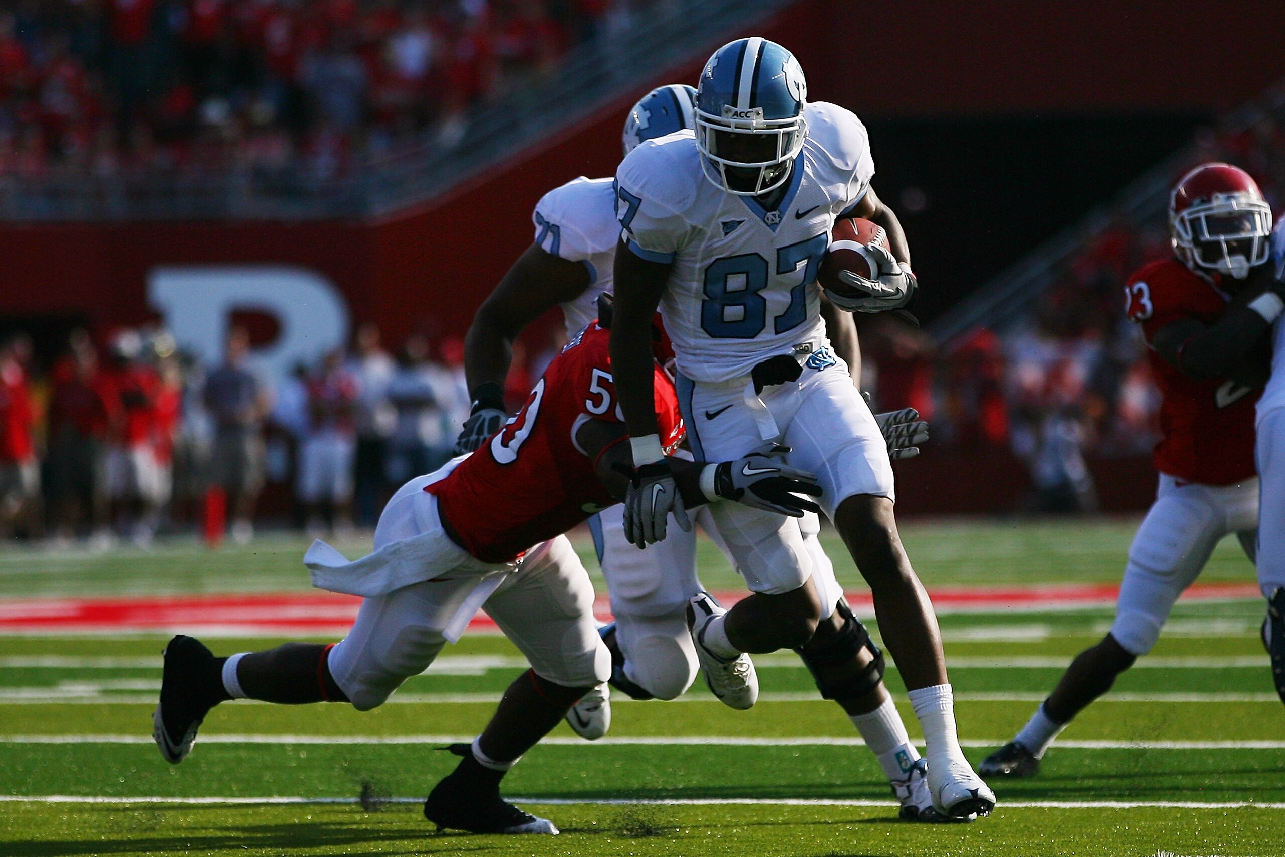 NEW BRUNSWICK, NJ - SEPTEMBER 25:  Jheranie Boyd #87 of the North Carolina Tar Heels breaks the tackle of Antonio Lowery #50 of the Rutgers Scarlet Knights during the second quarter at Rutgers Stadium on September 25, 2010 in New Brunswick, New Jersey.  (